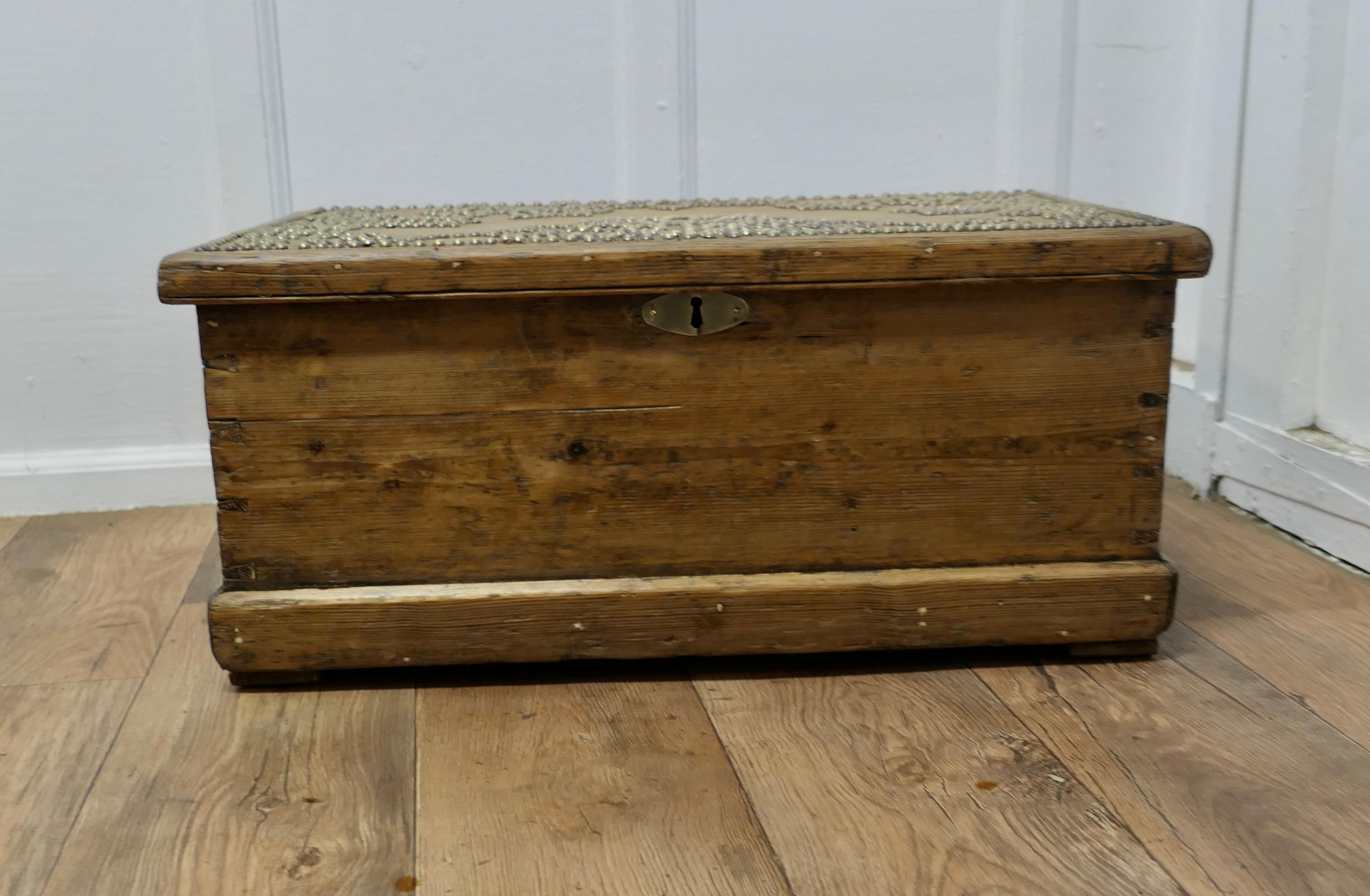 Decorated Victorian Pine Blanket Box with Stud-work Design
 
This is a very attractive pine box, it has been decorated with a tulip design in brass stud work 
The pine has darkened with age, the box has its original iron carrying handles and iron