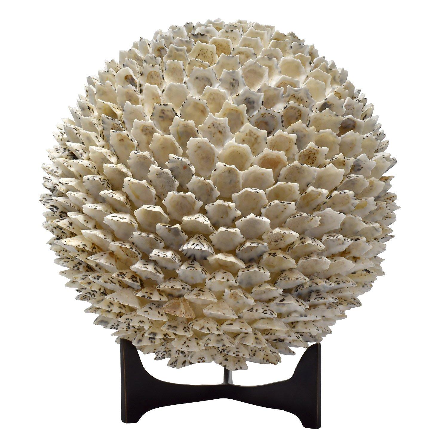 A natural shell ball of primarily white shells attached at one end of the shell. The result is a highly textured round form of organic material. Made from limpet shells.

Can be used with or without the black stand.

Measures: height on display