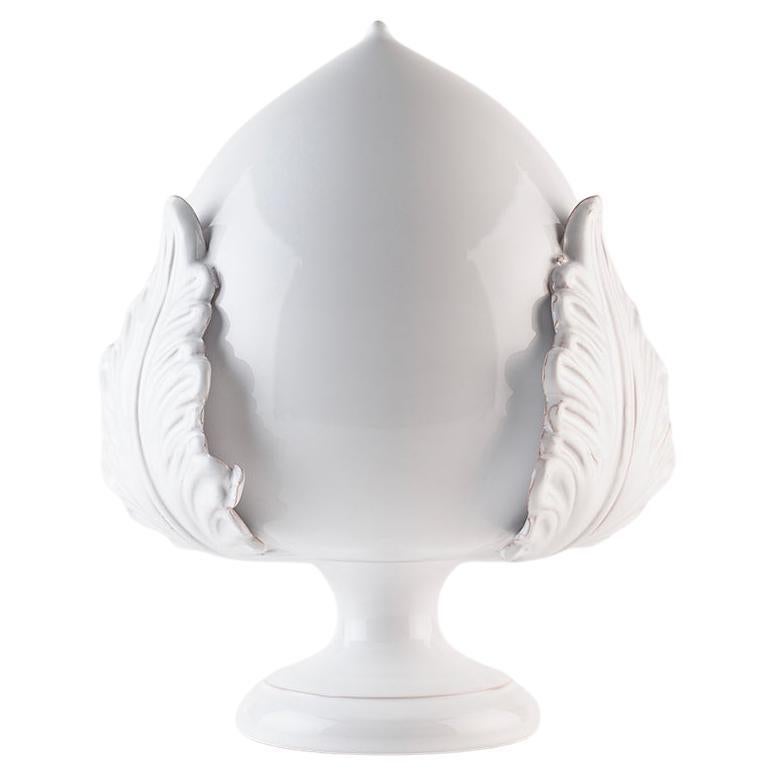 The Apulian Pumo is a symbol of prosperity, fertility and luck, represented by an acanthus bud. Traditionally, it was placed in front of houses to protect them from harm and to attract wealth and happiness to the family.

The Bottega is today