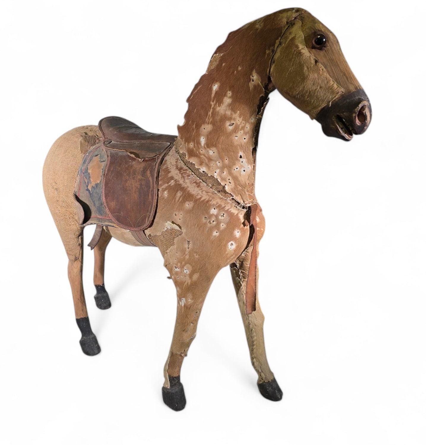 This elegant 19th-century carved wooden horse exudes timeless charm and character. Its beautifully aged surface, marked by natural wear, adds to its unique decorative appeal, making it a captivating piece for both antique collectors and interior