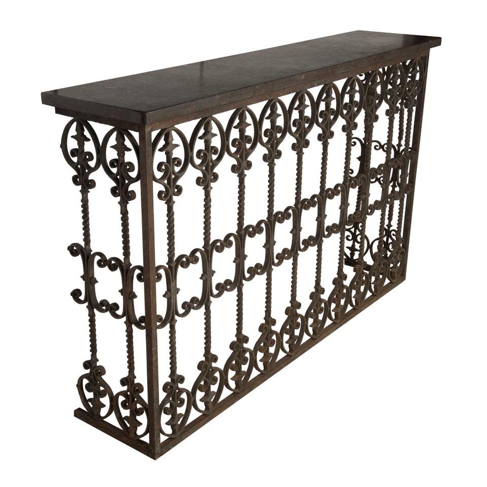 This antique decorative 19th century wrought iron balcony has a beautiful time-worn patina, and features a fossil marble-top of good depth as a later addition to the piece. The balustrades are of a wonderful spiraled design. This piece would make a
