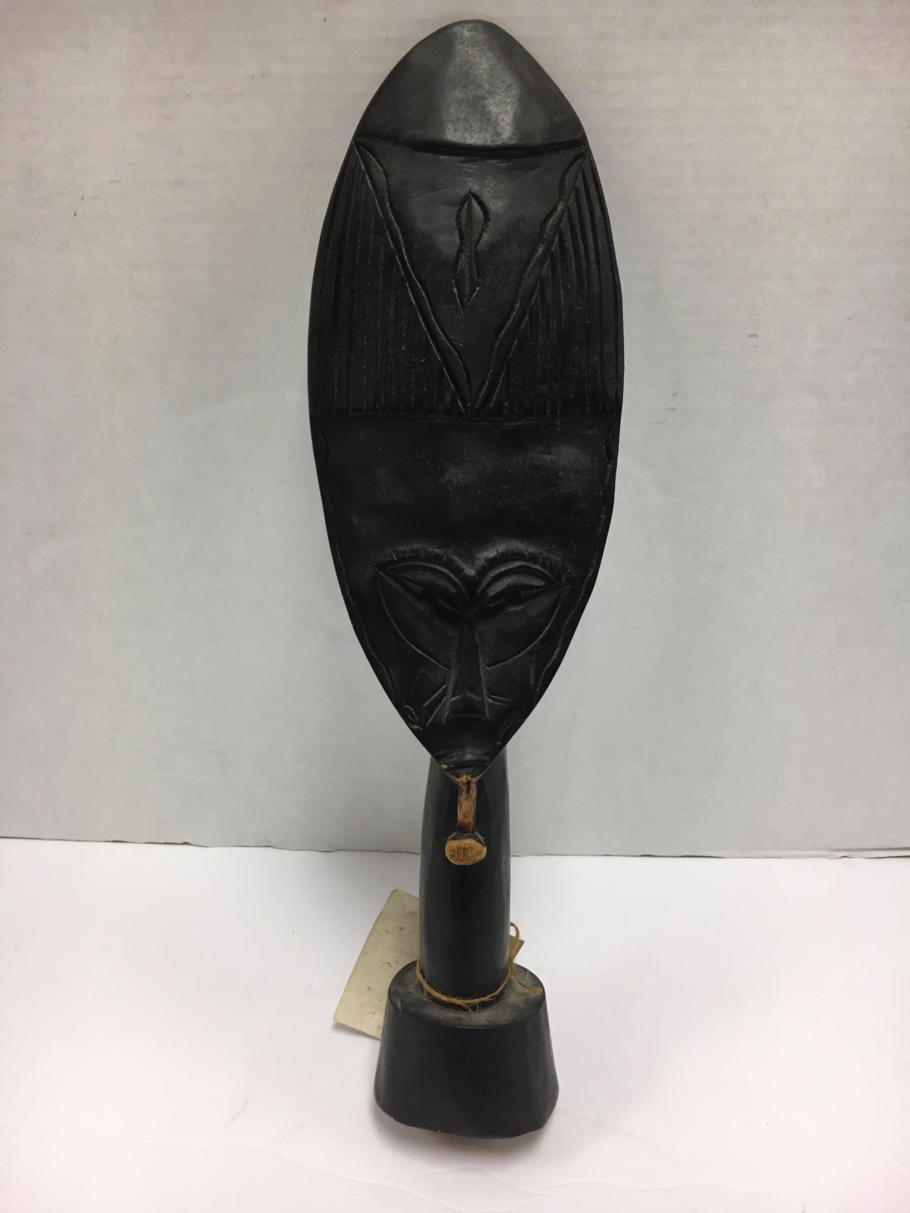 Coveted decorative African hand carved wood sculpture with graphic elements, circa 1960s
This is a decorative item from the 1960s, it was made for export, it is not an antique tribal mask.
It was made by a master carver from a single piece of wood