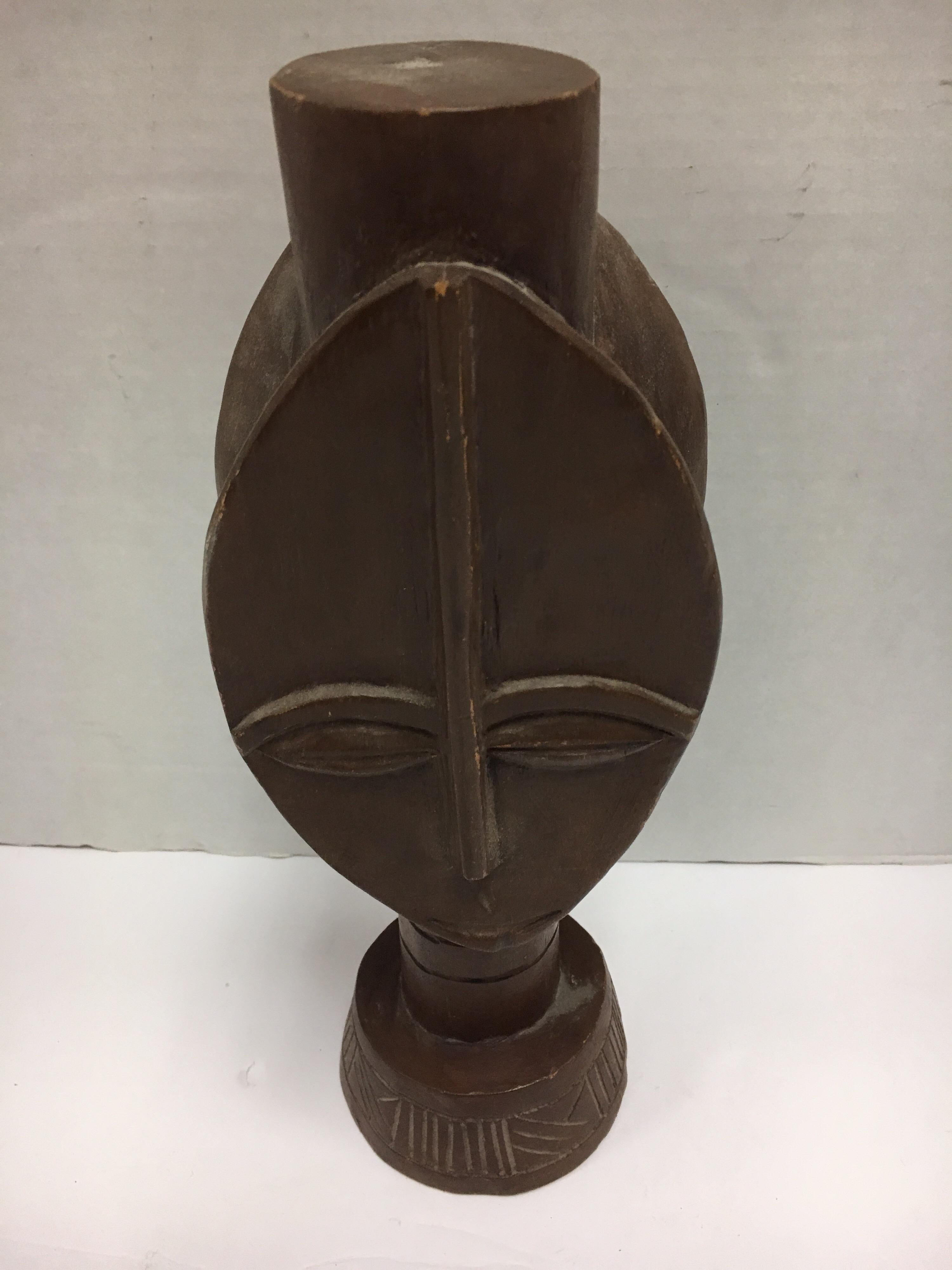 Coveted decorative African hand carved wood sculpture with graphic elements, circa 1960s
This is a decorative item from the 1960s, it was made for export, it is not an antique tribal sculpture.
It was made by a master carver from a single piece of