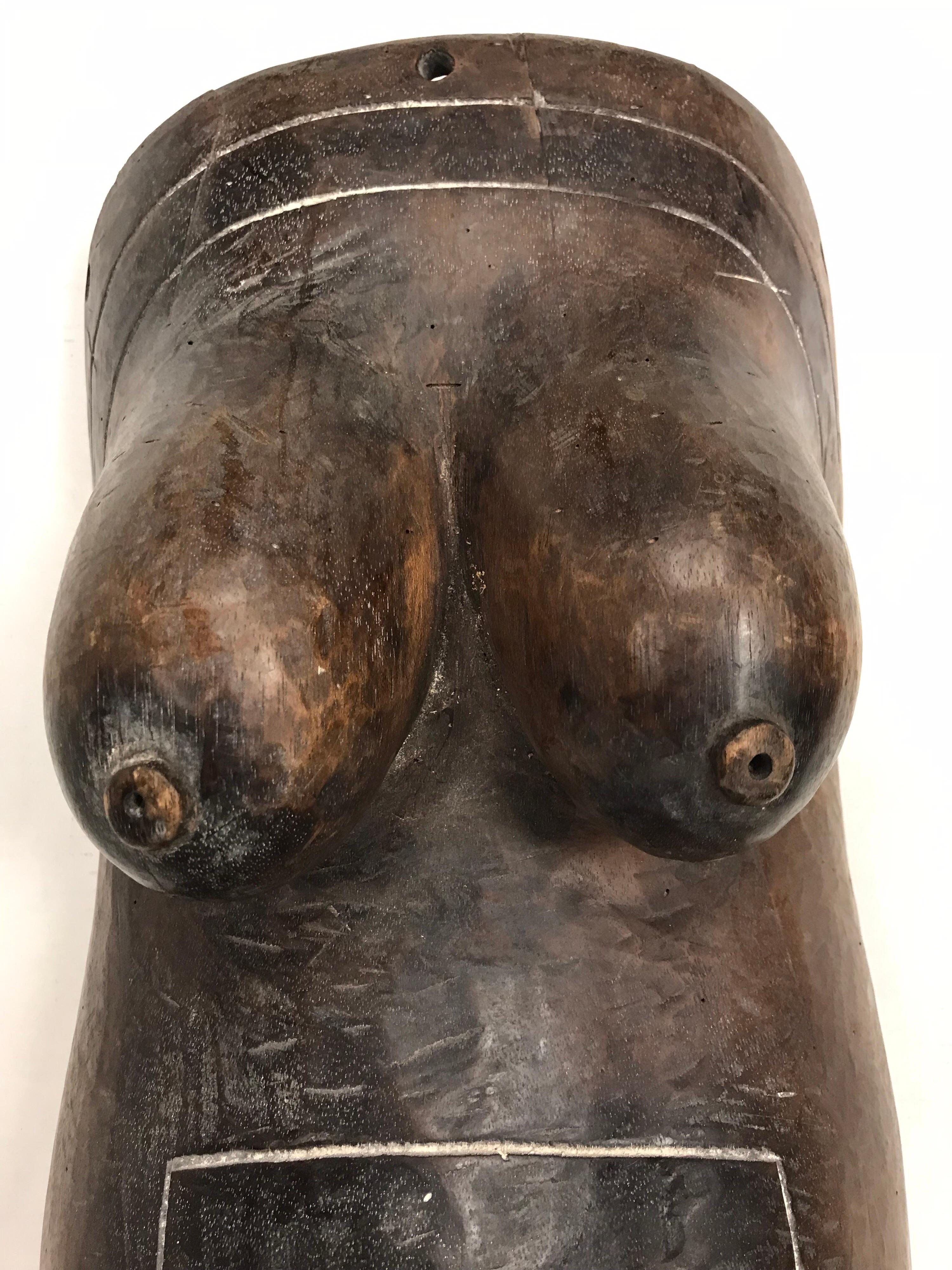 Carved wooden African female body mask depicting a torso with breasts and pregnant belly promoting fertility. What sets this sculpture apart is the fact that is life-size, see measurements below. 