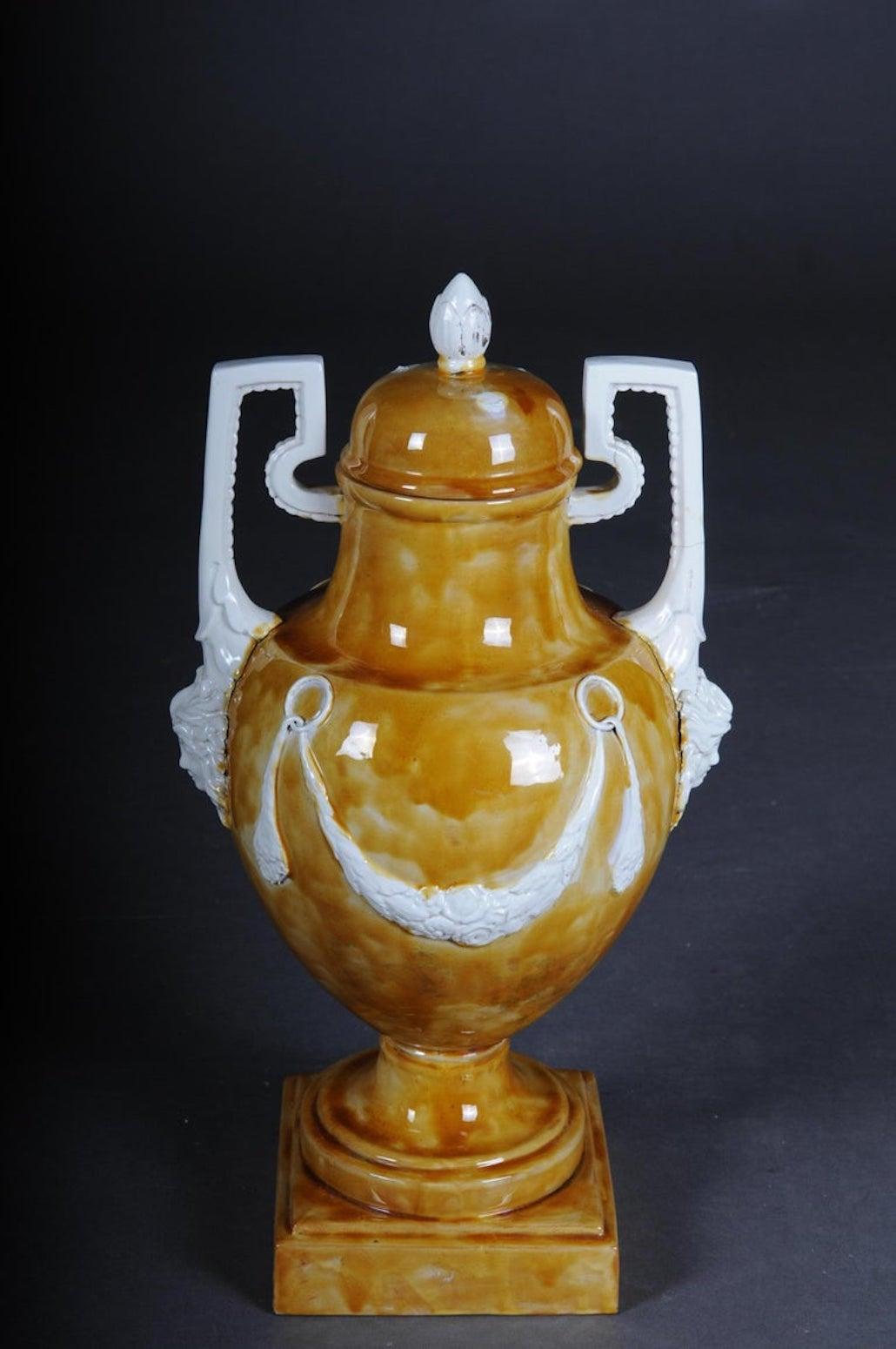Extremely decorative Amphora vase. With beautiful mascarons.
Classic style Amphora. Brown background with white Classic elements.
Vase shape with white garland on rectangular plinth. Very decorative.

