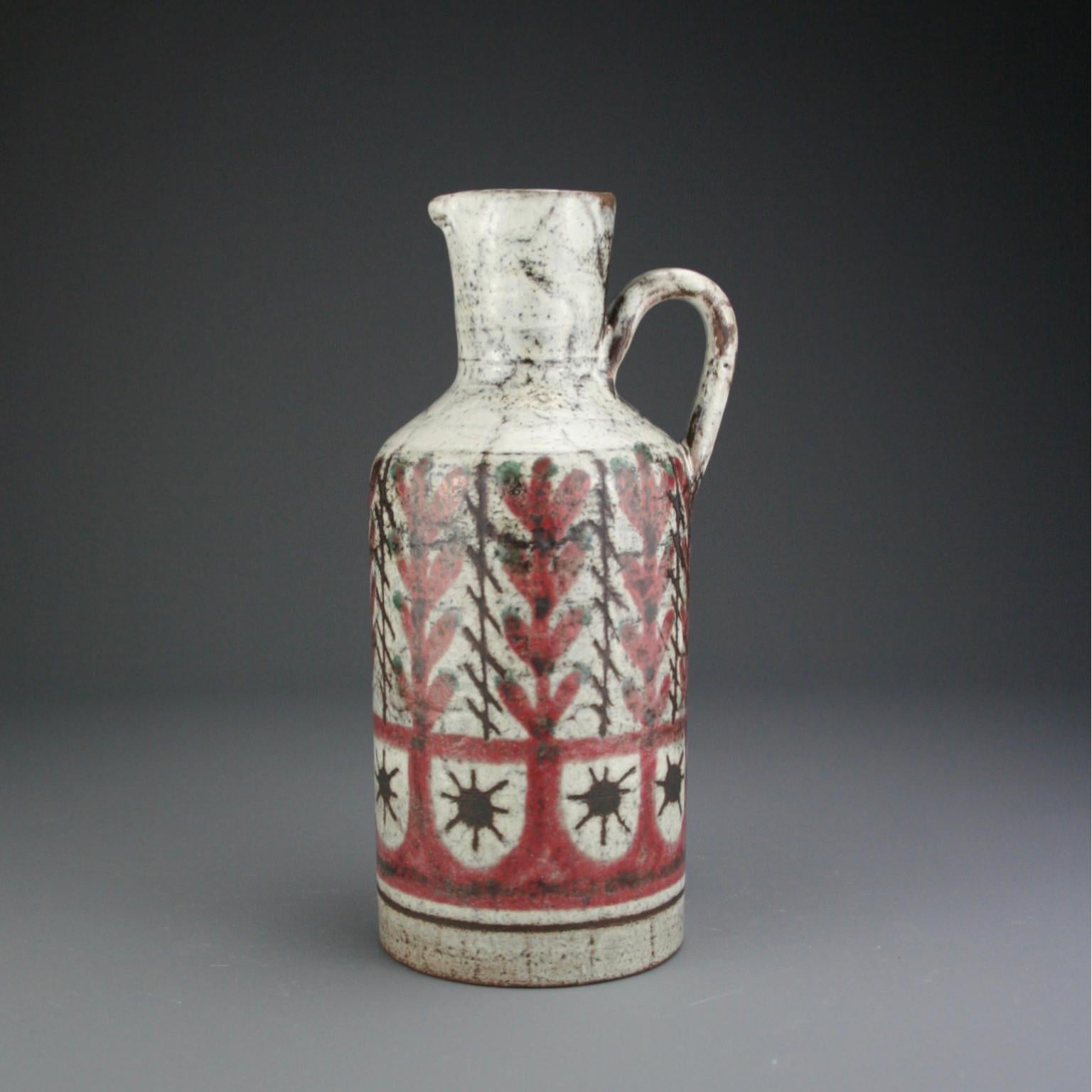 This French midcentury ceramic pitcher was handmade by Gustave Reynaud, Le Mûrier (circa 1950s). 

The pitcher is hand painted with repeating, abstract mulberry red and brown leaf motif on a delicate grey and off-white glaze base.  

About the