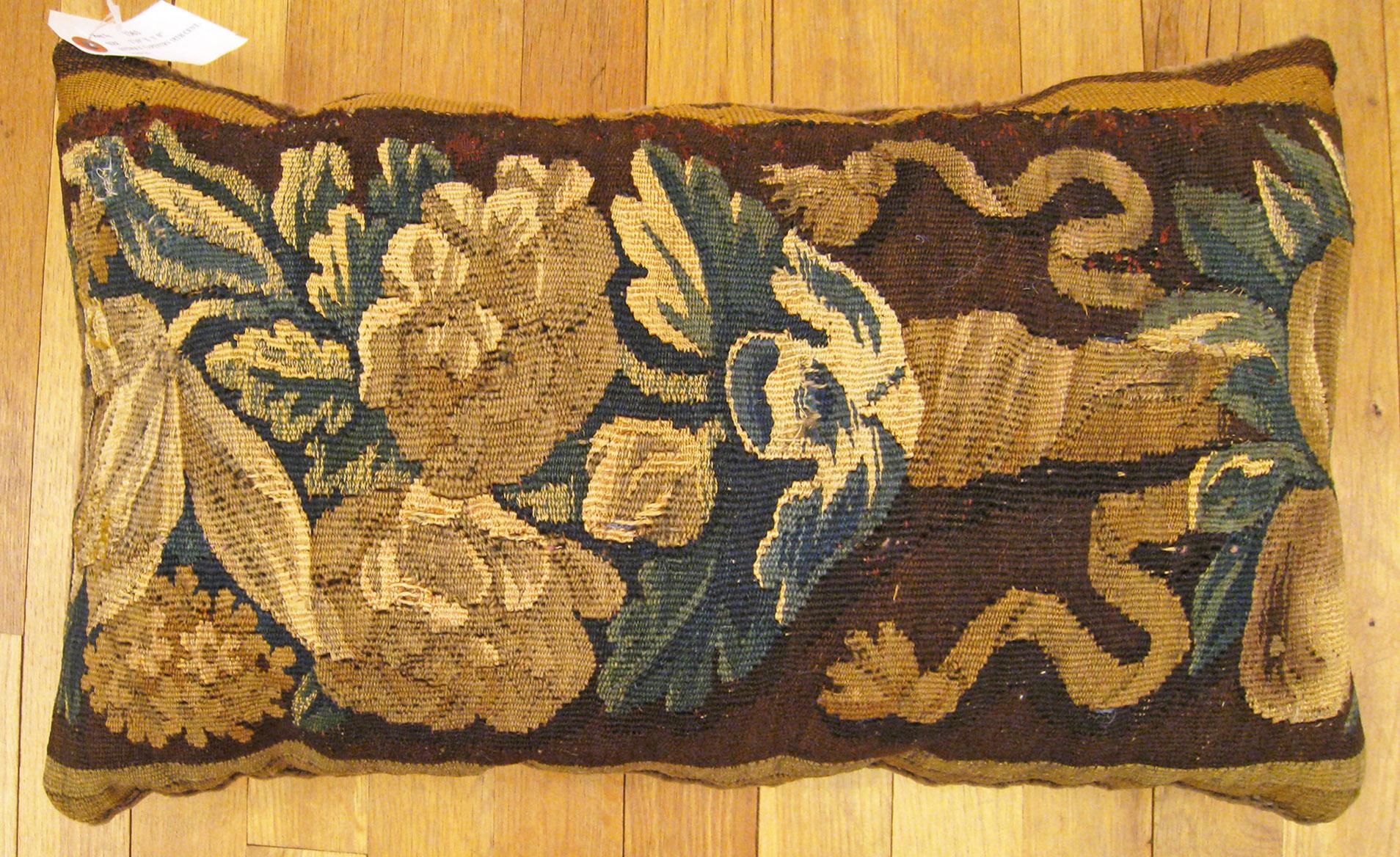 Antique 18th century Tapestry pillow; size 1'0” x 1'10”.

An antique decorative pillow with floral elements allover a brown central field, size 1'0” x 1'10”. This lovely decorative pillow features an antique fabric of a 18th century tapestry on