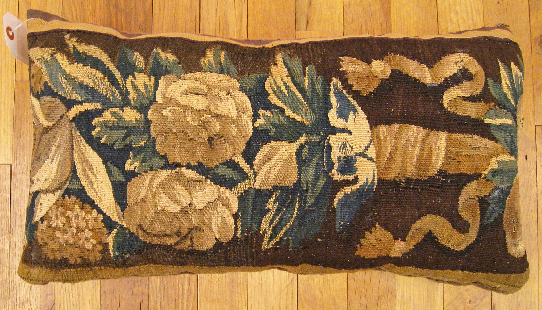 Antique 18th century Tapestry pillow; size 1'0” x 1'10”.

An antique decorative pillow with floral elements allover a brown central field, size 1'0” x 1'10”. This lovely decorative pillow features an antique fabric of a 18th century tapestry on