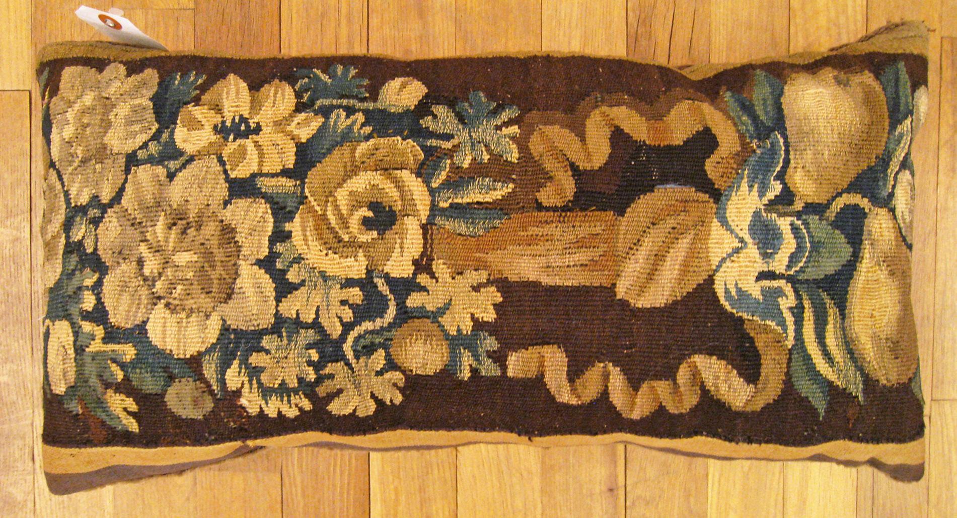 Antique 18th century tapestry pillow; size 1'0” x 1'10”.

An antique decorative pillow with floral elements allover a brown central field, size 1'0” x 1'10”. This lovely decorative pillow features an antique fabric of a 18th century tapestry on