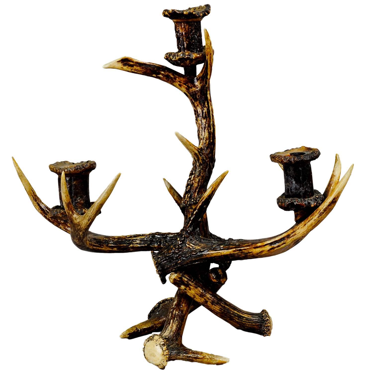 Decorative antique Antler candelabra with three spouts 1900

A countrycore antique three-armed candleholder, made of antlers from the deer and virginia deer. It was executed in the Black Forest, Germany around 1900. This candelaber would make an