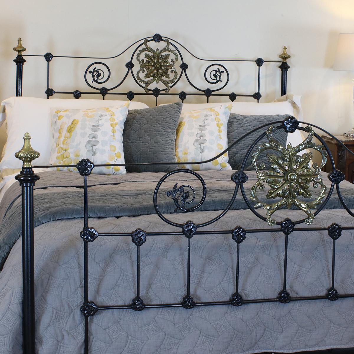 A cast iron bed with decorative panels and cast brass central plaques and finials.

This bed accepts a British king size or American queen size (5ft wide, 60 inches or 150 cm) base and mattress set.

The price is for the bed frame alone. The