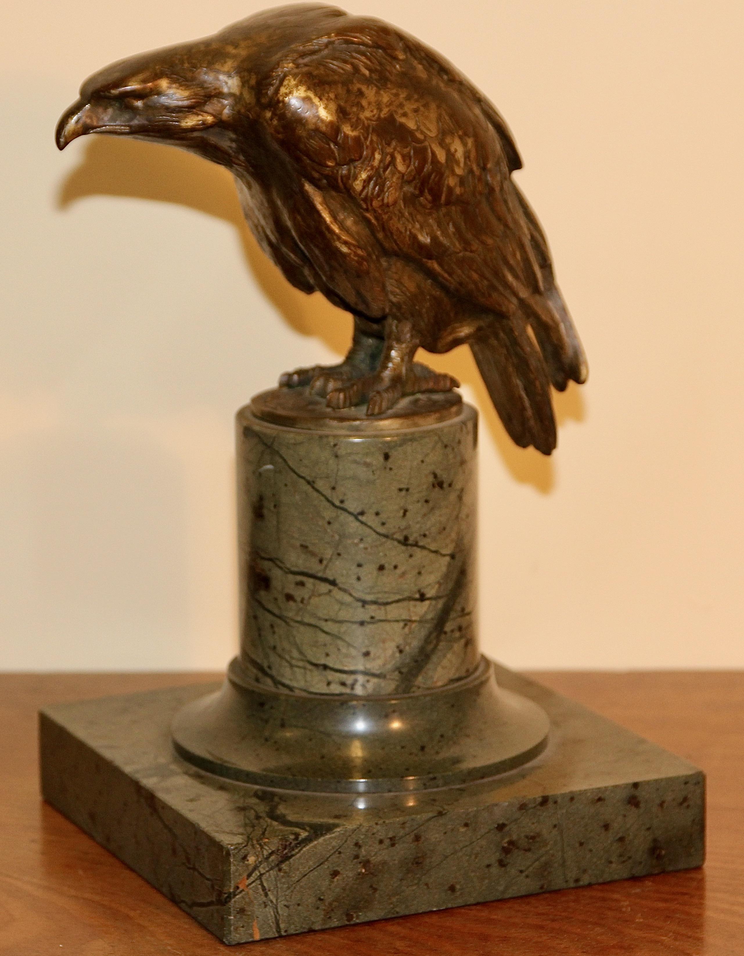 Decorative antique bronze sculpture of an eagle, on a marble base.