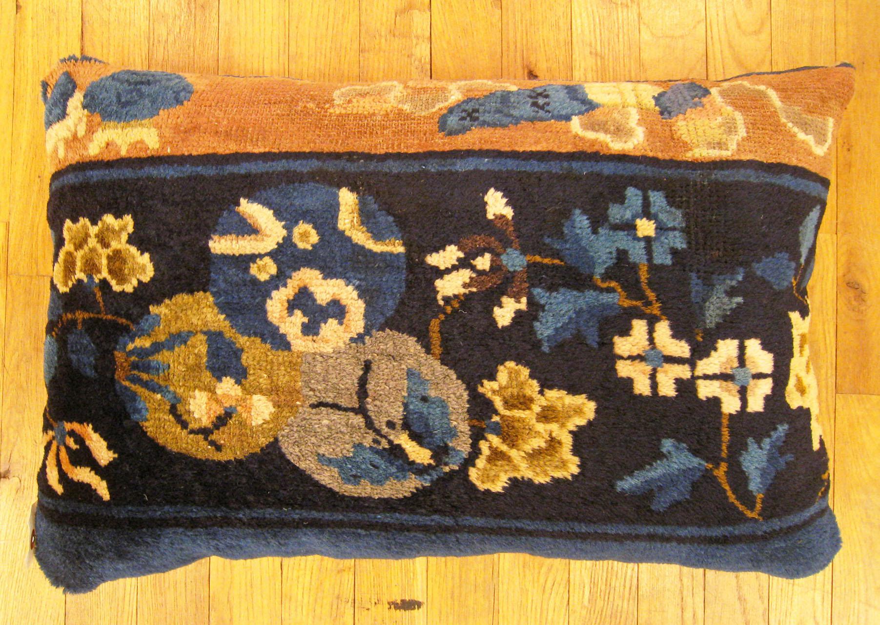 Antique Chinese Pillow; size 24” x 16” (2’ 0” x 1’ 4”). 

An antique decorative pillow with floral elements in an art deco style in a navy central field, size 24” x 16” (2’ 0” x 1’ 4”). This lovely decorative pillow features an antique fabric of a