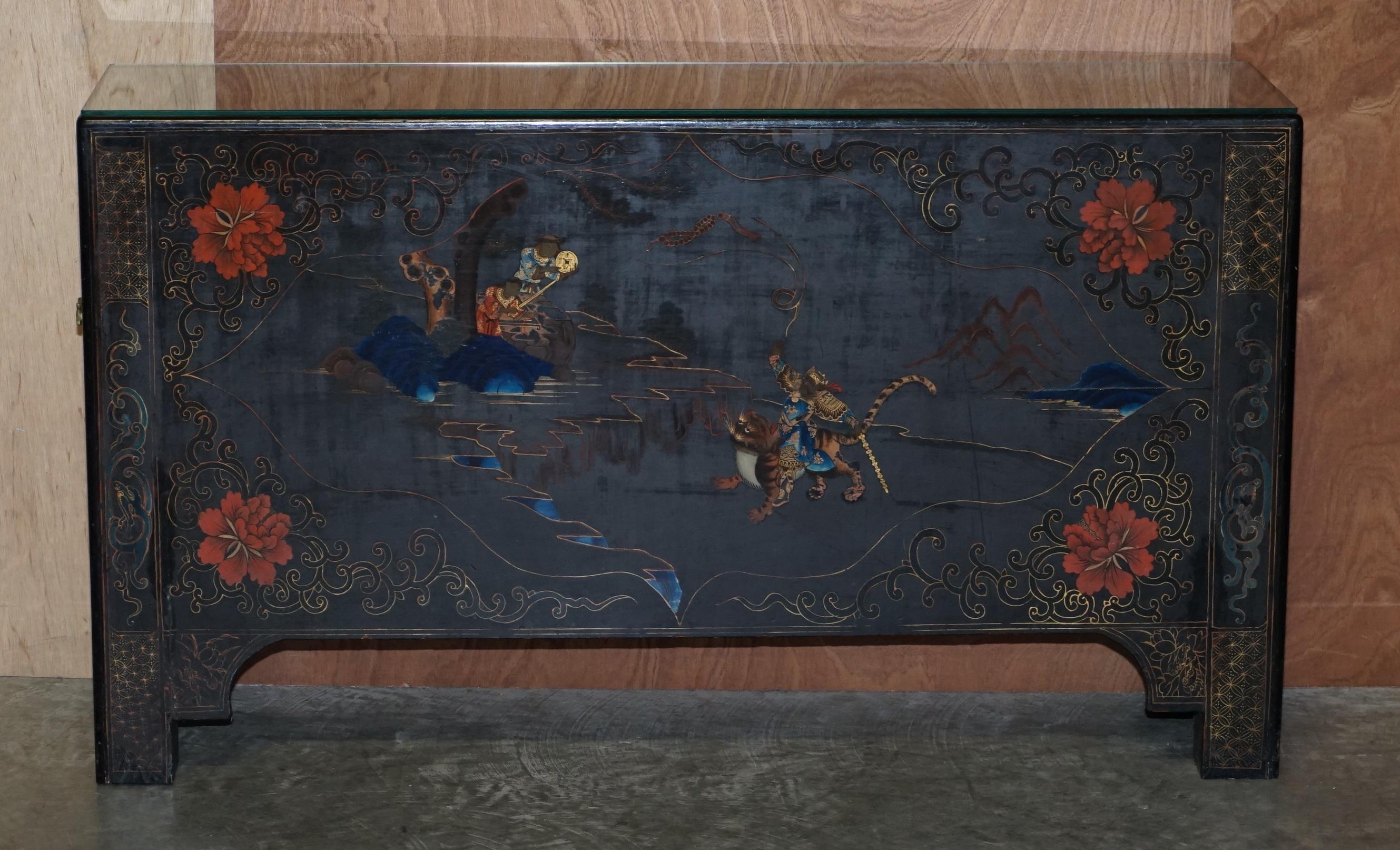 We are delighted to offer this very nicely made, Polychrome painted and lacquered console sideboard

This is a very good-looking and decorative piece, you have a god like warrior chap riding a tiger in the mountains with some onlookers who are
