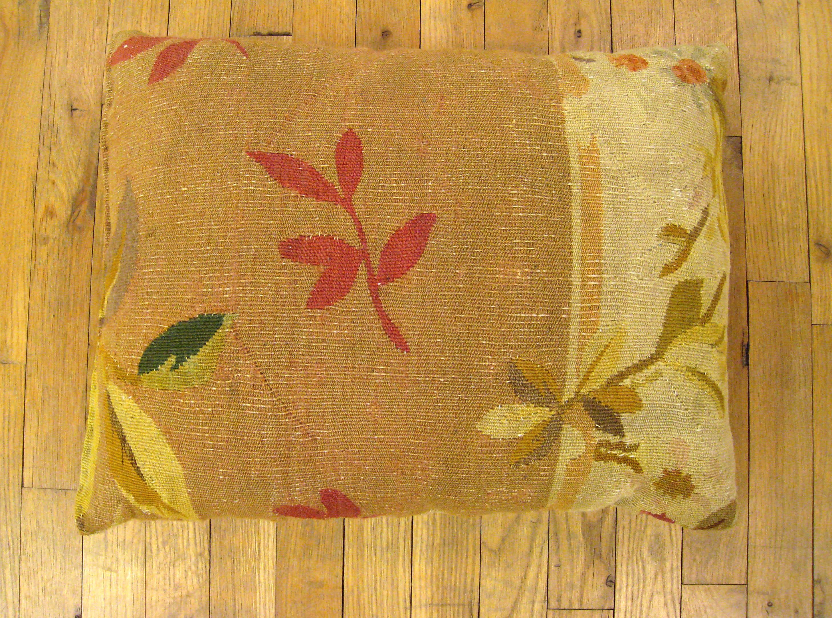 A lovely decorative pillow fronted by an antique French Aubusson carpet, and backed with a beige colored striped velvet fabric, in the size: 22