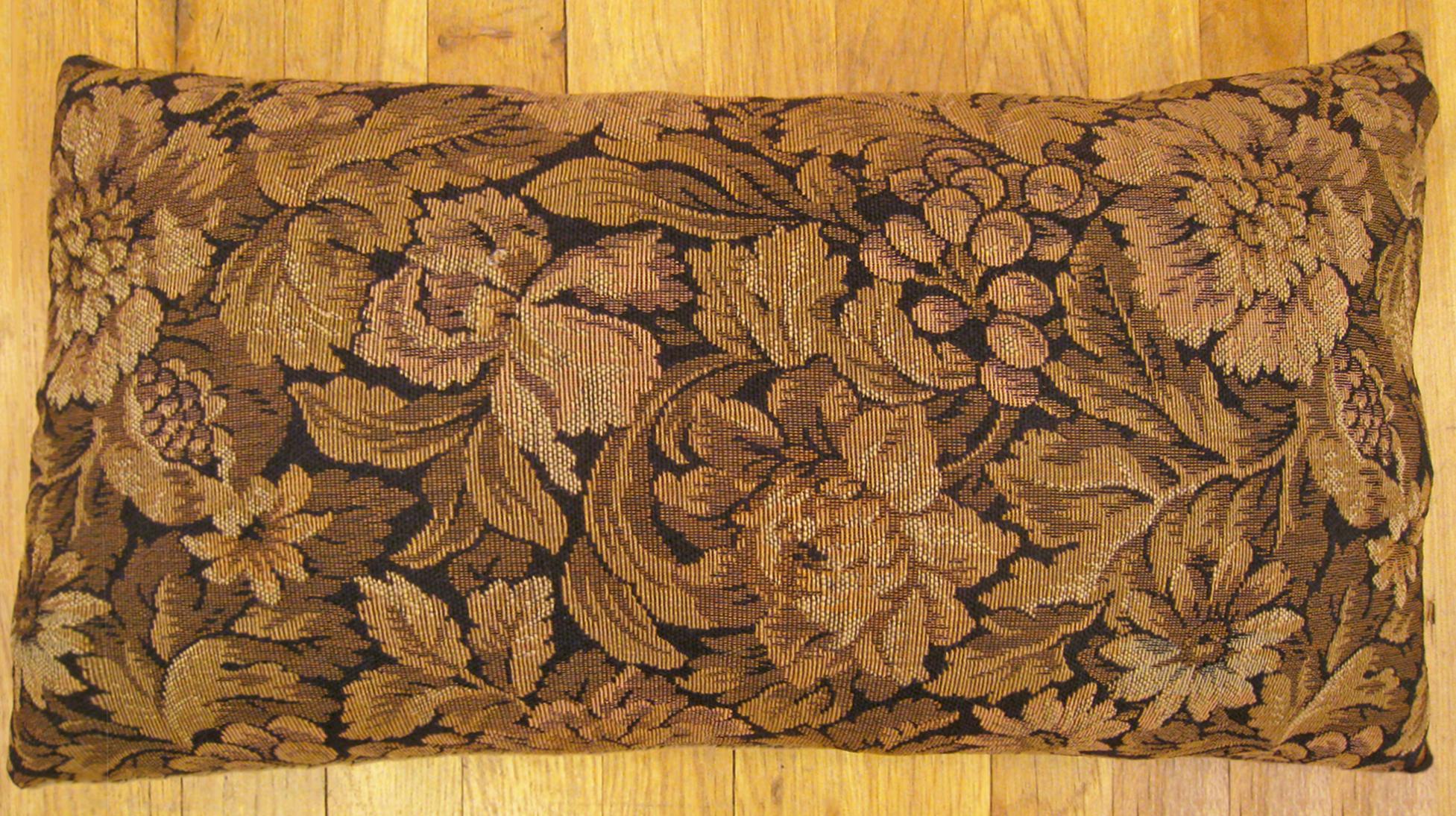 Antique French Tapestry Pillow; size 24” x 14” (2’ 0” x 1’ 2”). 

An antique decorative pillow with floral elments allover a brown central field, size 24” x 14” (2’ 0” x 1’ 2”). This lovely decorative pillow features an antique fabric on front which