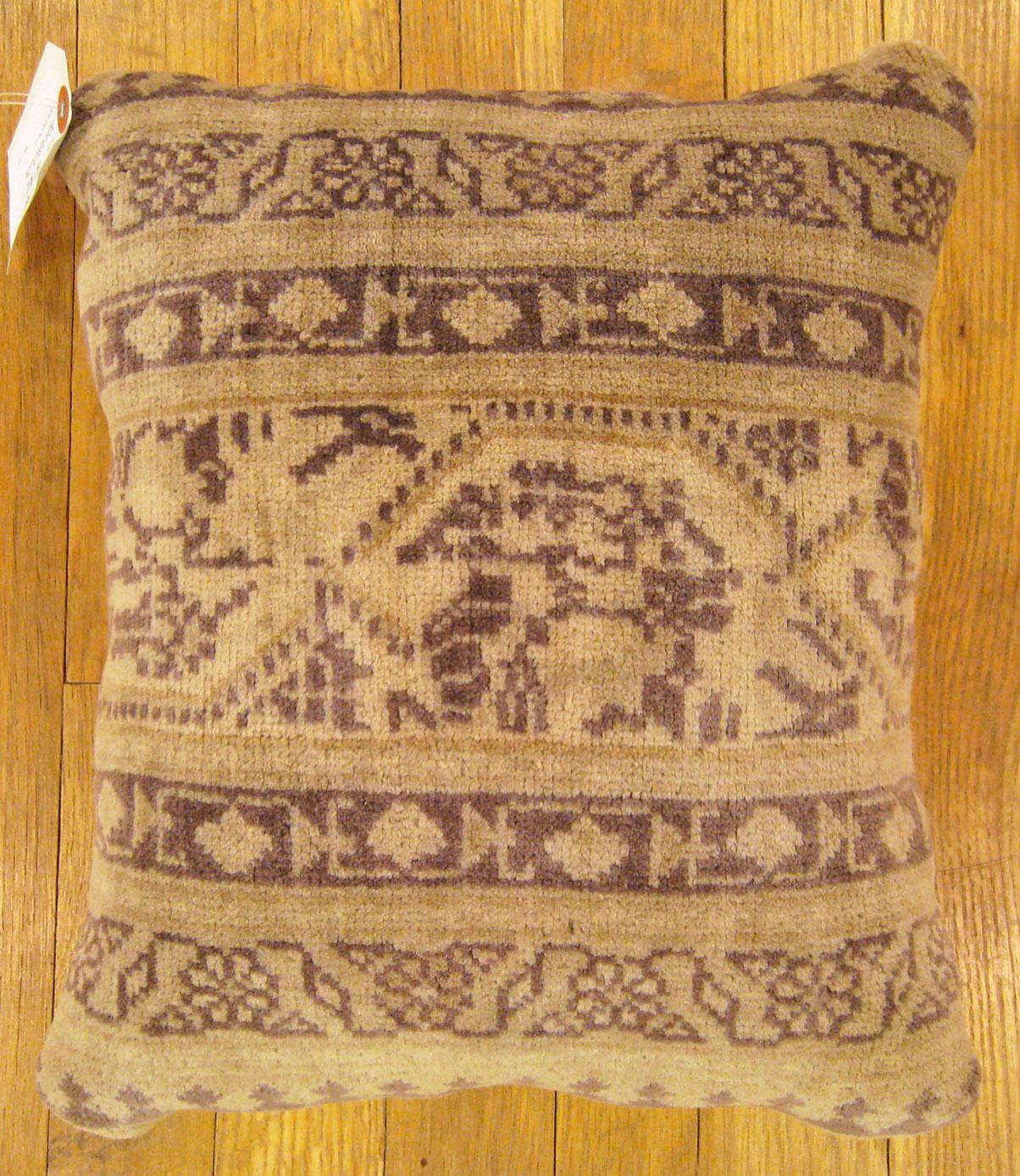 Antique Indian Agra carpet pillow; size 1'2” x 1'0”.

An antique decorative pillow with geometric abstracts allover a cream central field, size 1'2” x 1'0”. This lovely decorative pillow features an antique fabric of a Agra rug on front which is