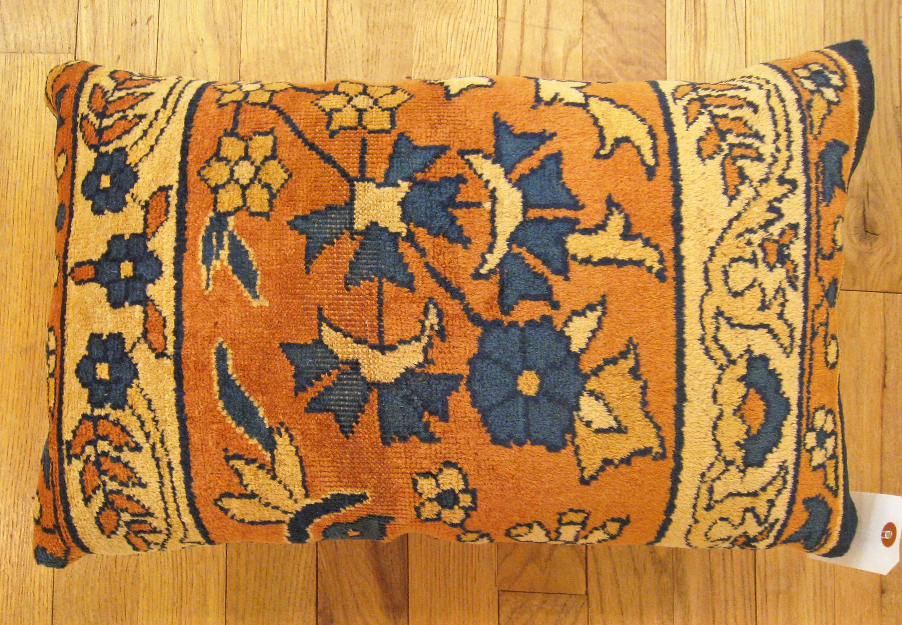Antique Indian Agra rug pillow; size 1'8” x 1'1”.

An antique decorative pillow with floral elements allover a salmon central field, size 1'8” x 1'1”. This lovely decorative pillow features an antique fabric of a Agra rug on front which is