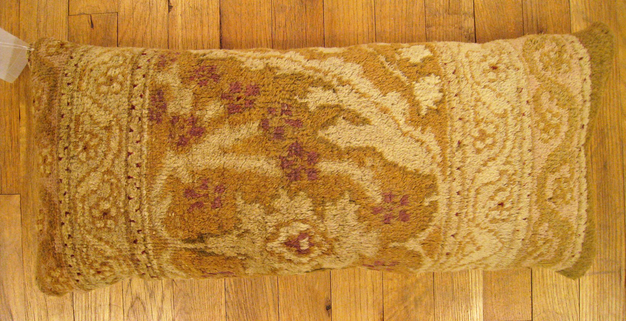 Antique Indian Agra rug pillow; size 2'0” x 1'0”.

An antique decorative pillow with floral elements allover a light brown central field, size 2'0” x 1'0”. This lovely decorative pillow features an antique fabric of a Agra carpet on front which is
