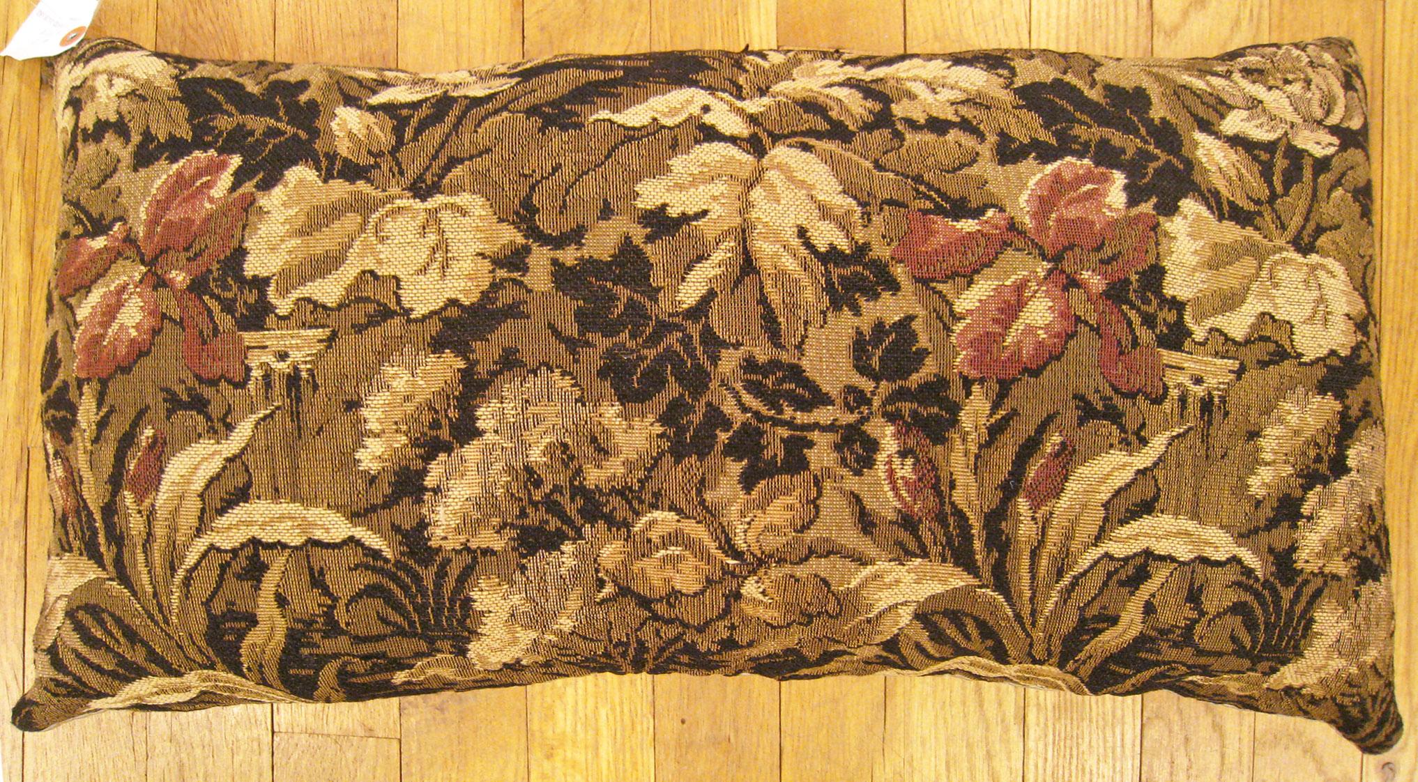 Antique Jacquard tapestry pillow; size 1'0” x 2'0”.

An antique decorative pillow with a garden design allover a light brown central field, size 1'0