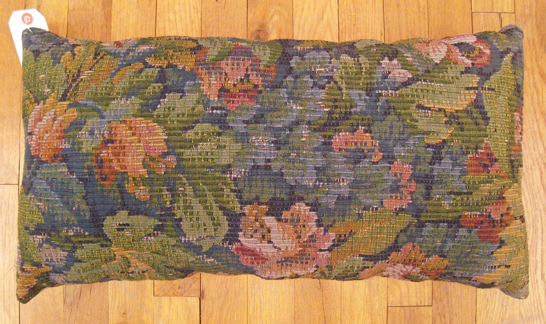 Antique Jacquard Tapestry Pillow; size 1'0” x 2'0”.

An antique decorative pillow with floral elements allover a blue green central field, size 1'0