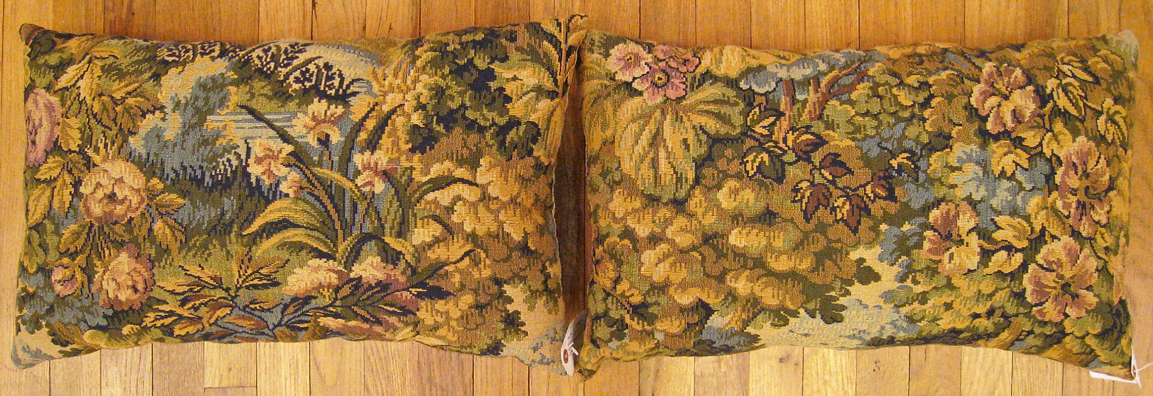 A pair of antique jacquard tapestry pillows ; size 1'3” x 2'0” each.

An antique decorative pillows with floral elements allover a soft blue central field, size 1'3