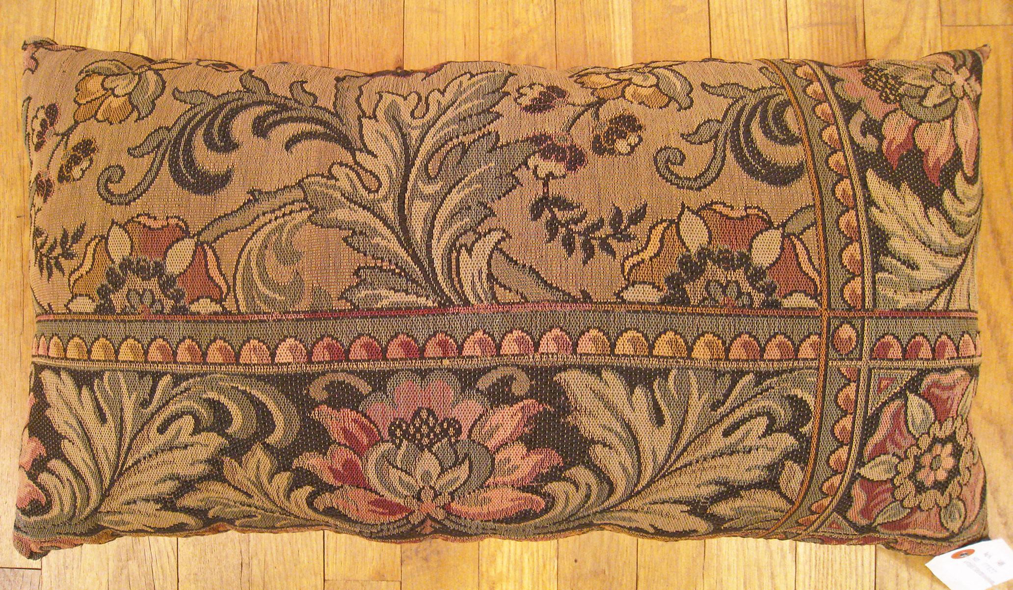 Antique Jacquard Tapestry pillow; size 1'3” x 2'2”.

An antique decorative pillow with floral elements allover a brown central field, size 1'3
