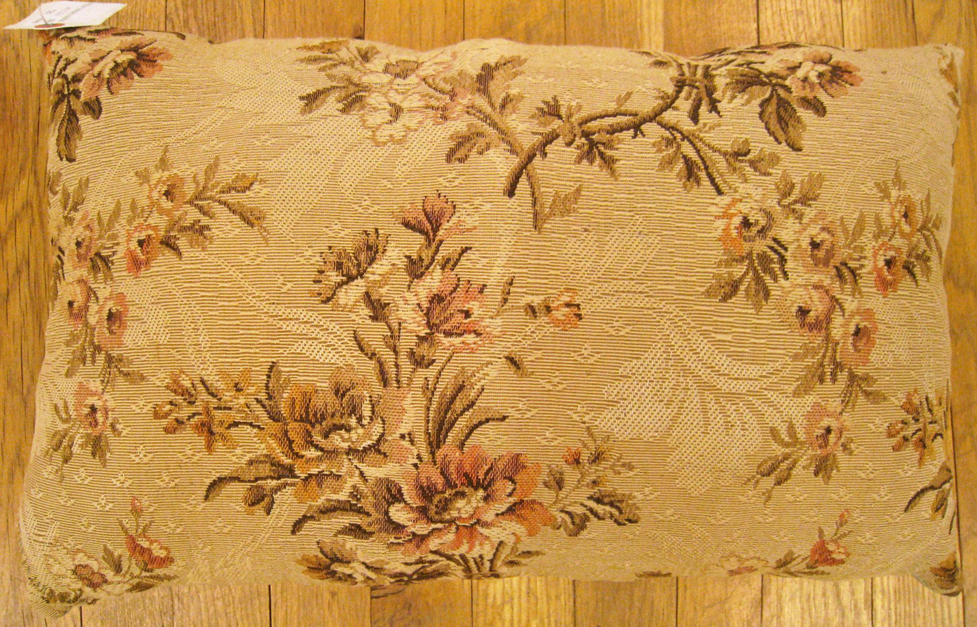 Antique jacquard tapestry pillow; size 1'2” x 1'9”.

An antique decorative pillow with floral elements allover a dusty rose central field, size 1'2