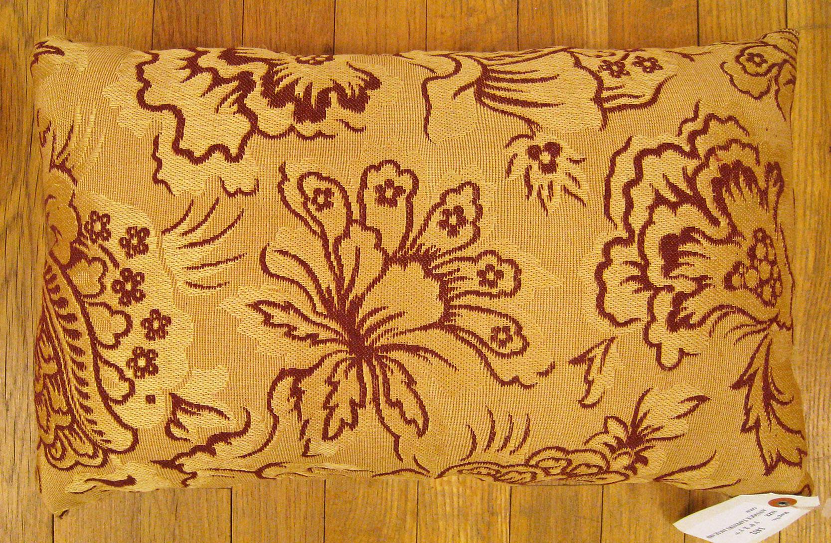 Antique Jacquard Tapestry pillow; size 1'0” x 1'7”. 

An antique decorative pillow with floral elements allover a light gold central field, size 1'0