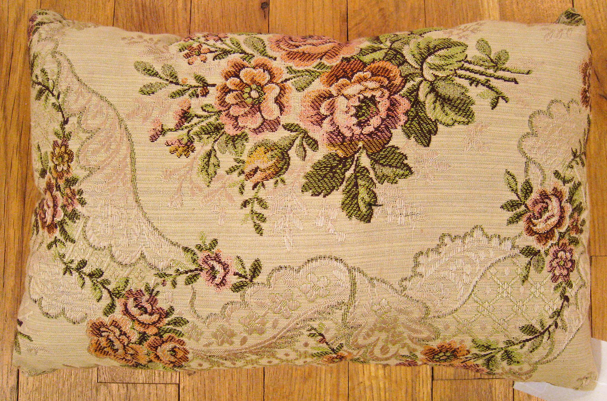 Antique Jacquard Tapestry pillow; size 0'10” x 1'3”. 

An antique decorative pillow with floral elements allover an ivory central field, size 0'10