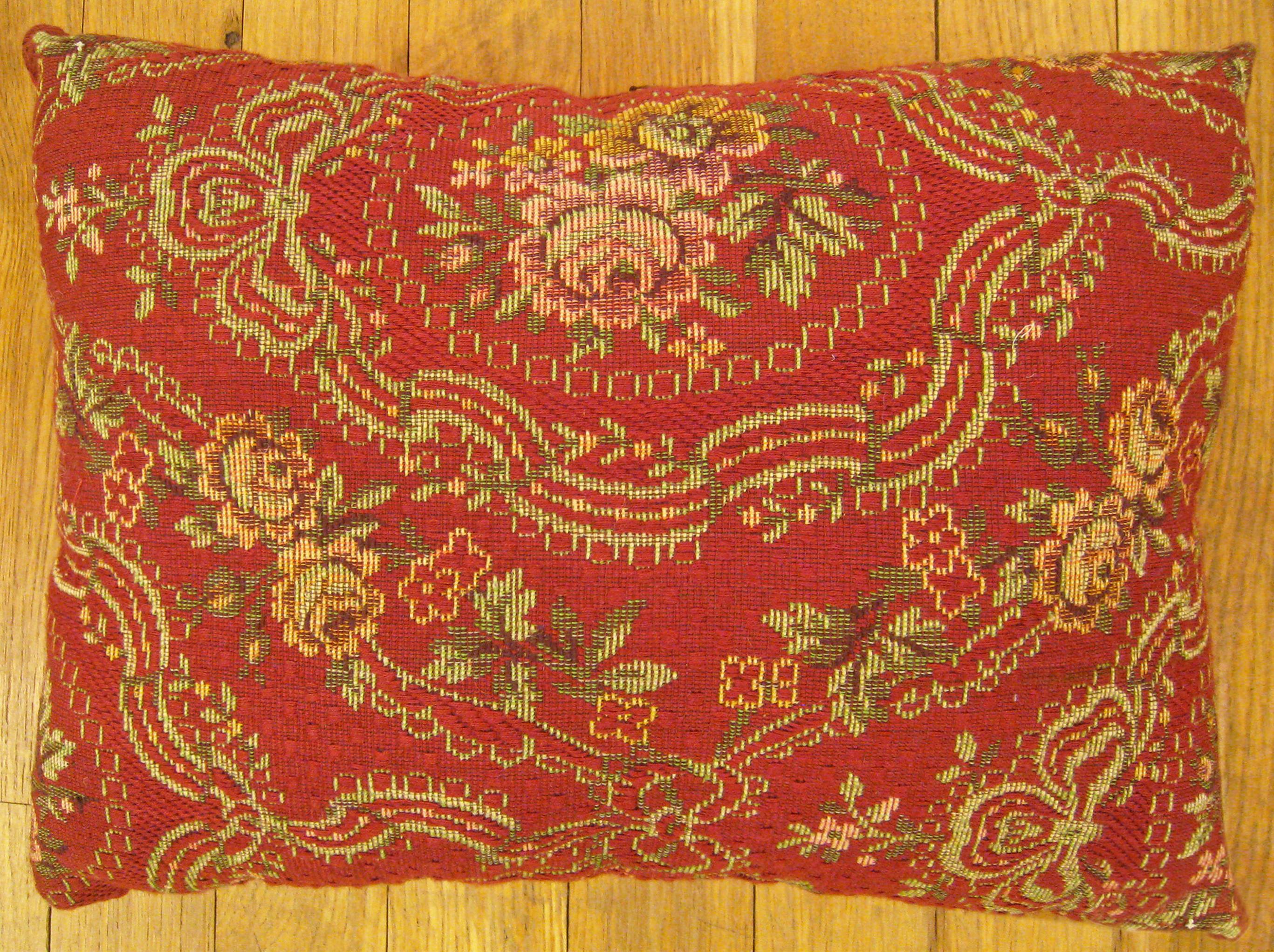 Antique Jacquard Tapestry pillow; size 1'0” x 1'3”.

An antique decorative pillow with floral elements allover a red central field, size 1'0