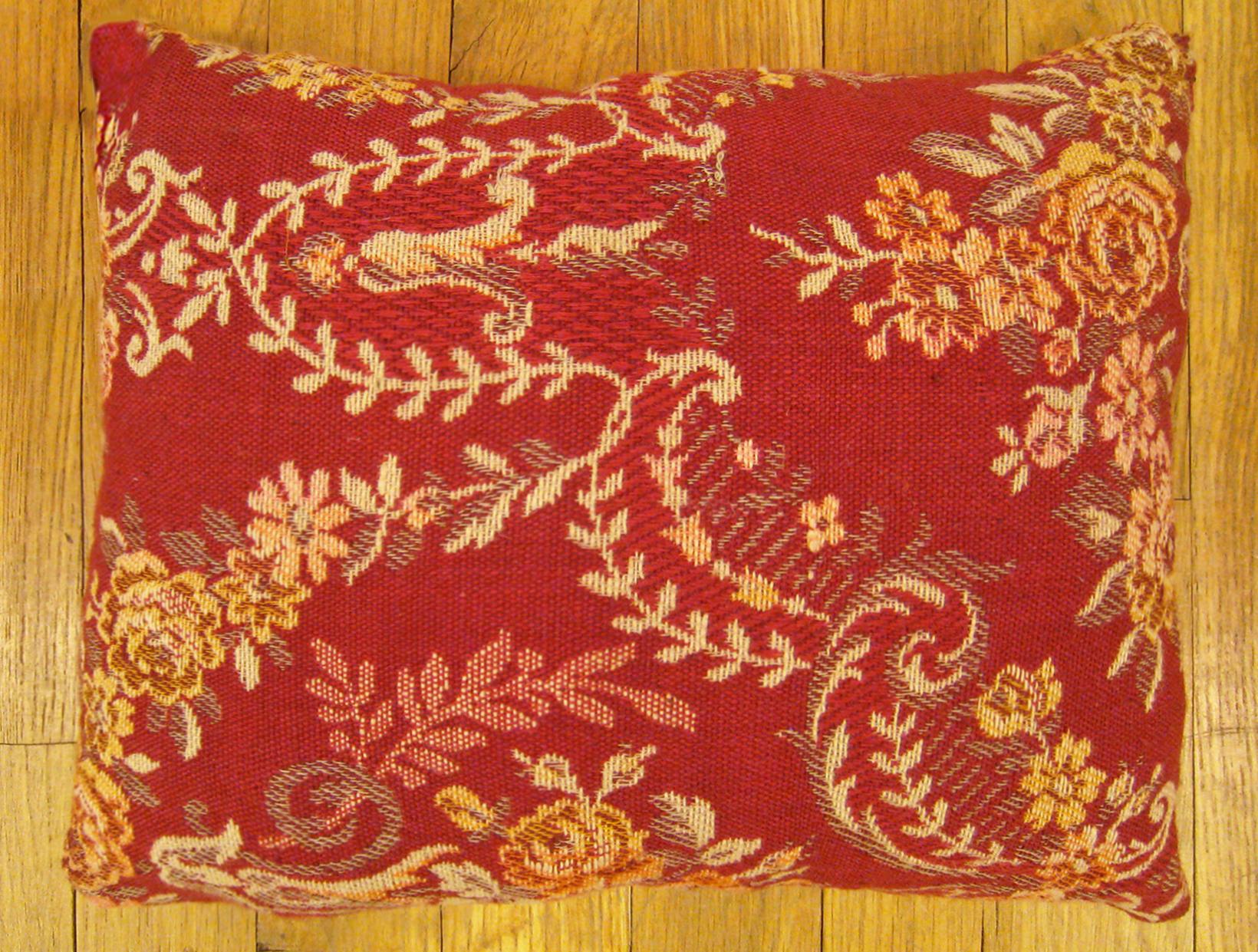 Antique Jacquard tapestry pillow; size 1'0” x 1'2”.

An antique decorative pillow with floral elements allover a red central field, size 1'0