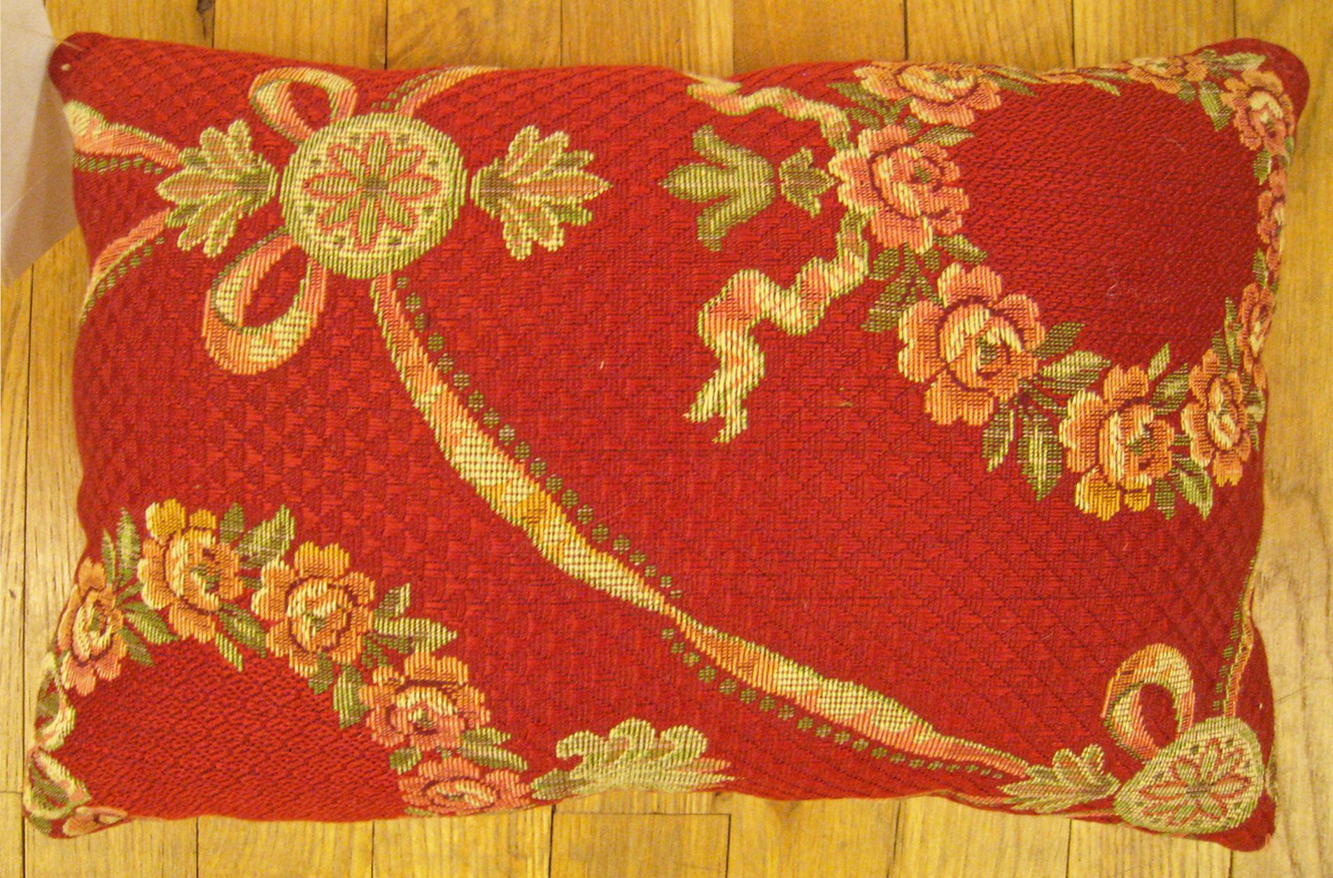 Antique Jacquard Tapestry pillow; size 1'0” x 1'3”.

An antique decorative pillow with floral elements allover a red central field, size 1'0