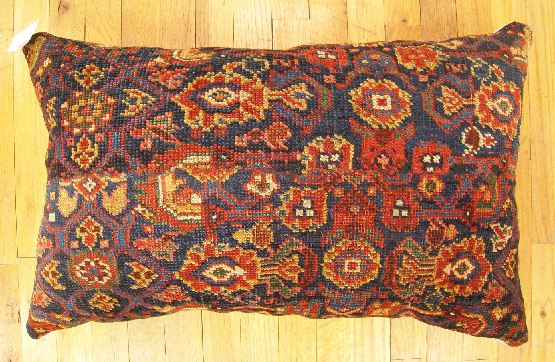 Antique Northwest Persian rug pillow; size 2'2” x 1'6”.

An antique decorative pillow with floral elements in a navy central field, size 2'2” x 1'6”. This lovely decorative pillow features an antique fabric of a Northwest Persian rug on front