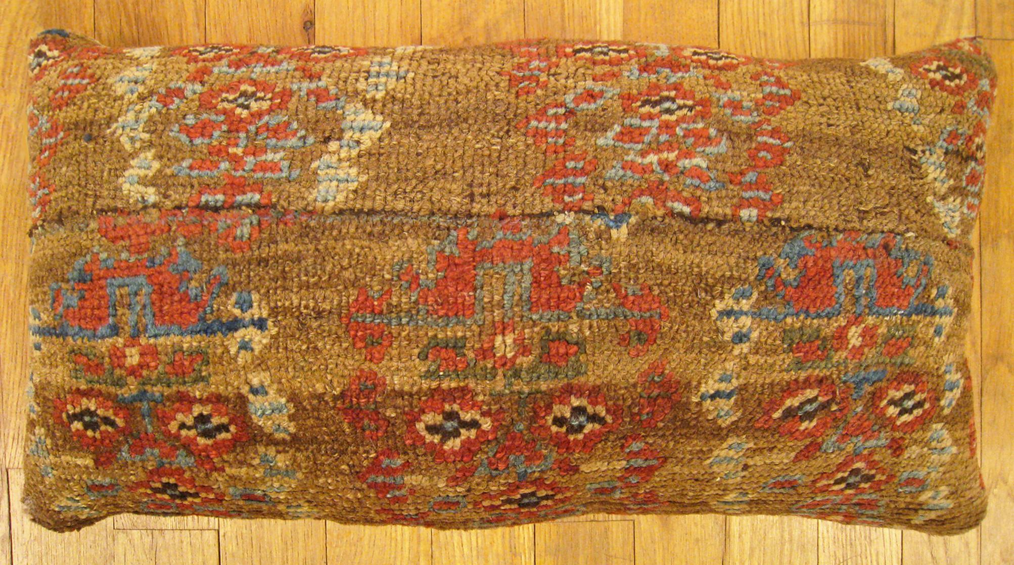 Antique Persian Bakshaish Carpet Pillow; size 1'9” x 1'0”.

An antique decorative pillow with floral elements in a camel central field, size 1'9” x 1'0”. This lovely decorative pillow features an antique fabric of a Persian Bakshaish carpet on front