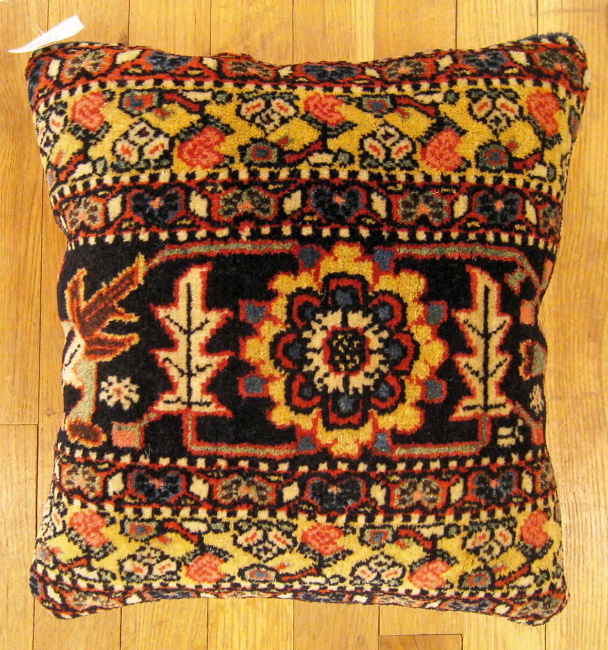 Antique Persian Bidjar carpet pillow; size 1'2” x 1'2”.

An antique decorative pillow with floral elements in a black central field, size 1'2” x 1'2”. This lovely decorative pillow features an antique fabric of a Persian Bidjar carpet on front