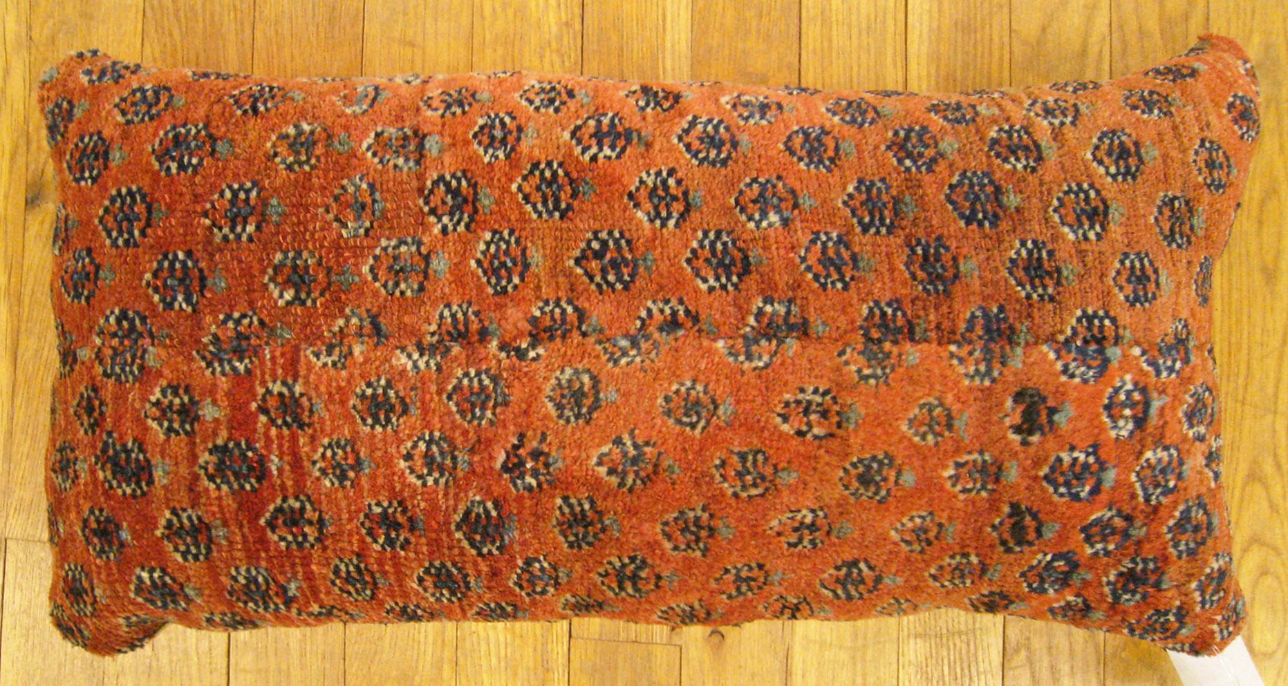 Antique Persian Saraband carpet pillow; size 2'0” x 1'2”.

An antique decorative pillow with floral elements allover a red central field, size 2'0” x 1'2”. This lovely decorative pillow features an antique fabric of a Saraband carpet on front
