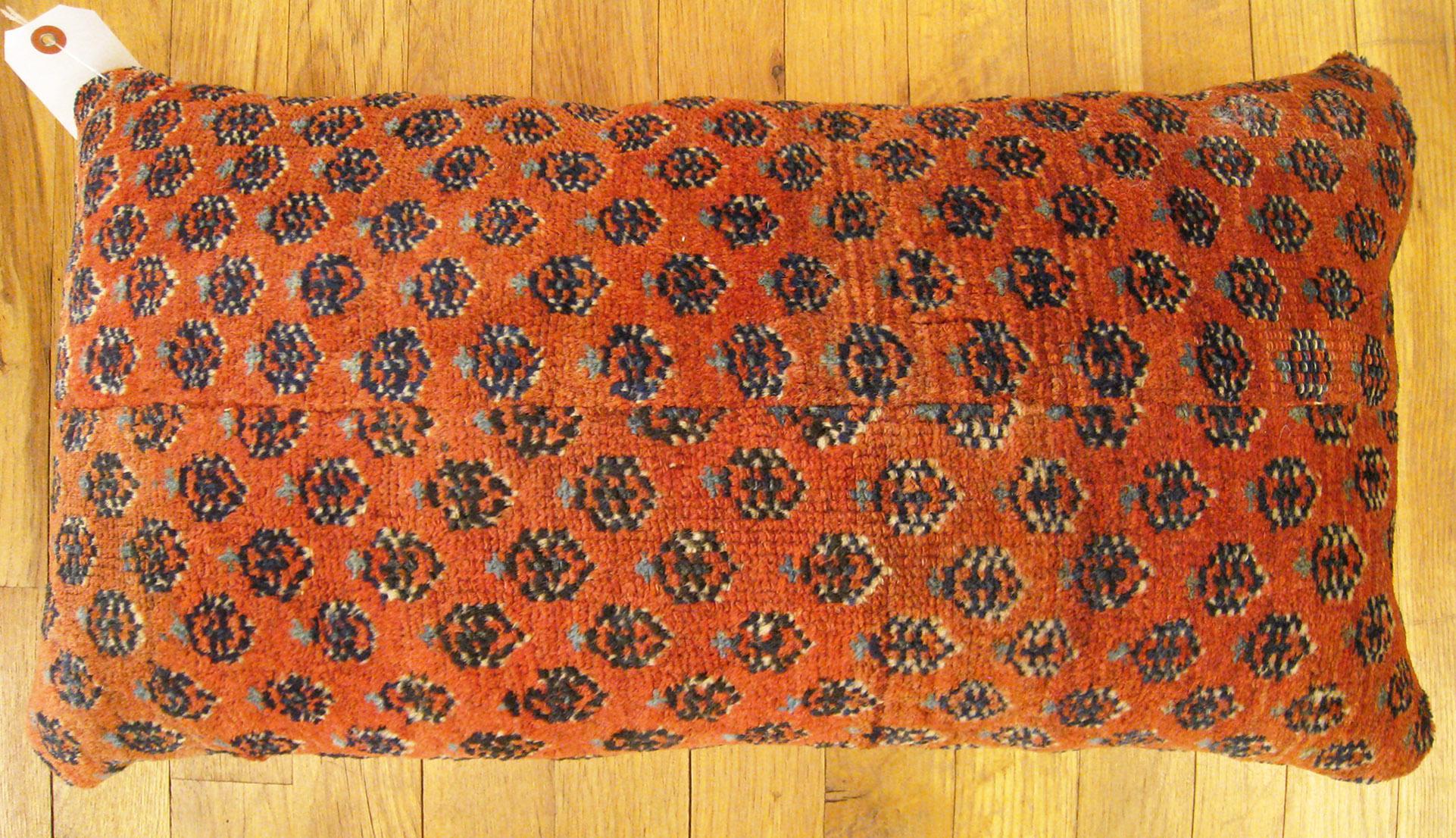 Antique Persian Saraband carpet pillow; size 2'0” x 1'2”.

An antique decorative pillow with floral elements allover a red central field, size 2'0” x 1'2”. This lovely decorative pillow features an antique fabric of a Saraband carpet on front