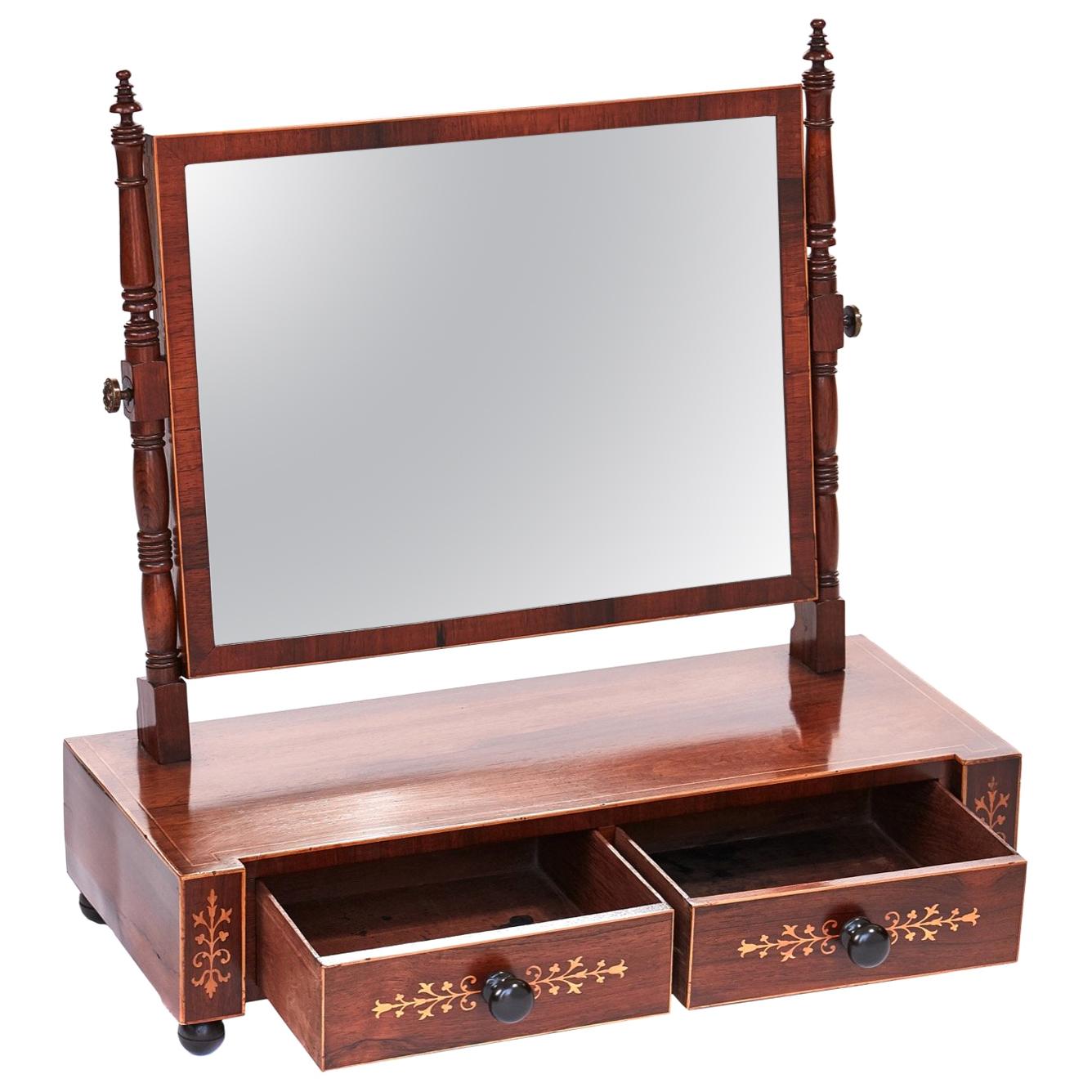 Decorative antique Regency hardwood inlaid dressing mirror having a rectangular swing mirror with boxwood line around the edge, two turned decorative supports each side with original brass knobs. The base having two drawers with decorative inlay on