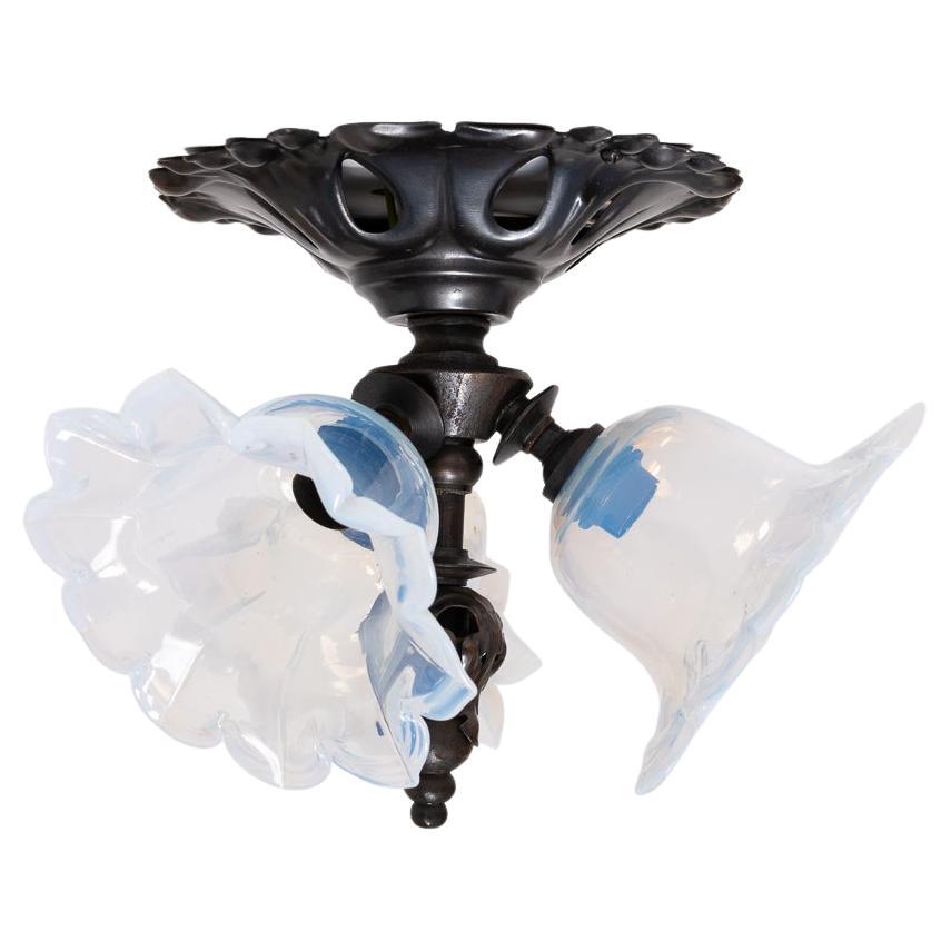 Beautiful Art Nouveau Style Flush Ceiling Light with Opalescent Glass Shades

A pretty three cluster flush to ceiling light fitting in a typical Art Nouveau style with a decorative pressed brass main body and centre finial.

Highest quality hand