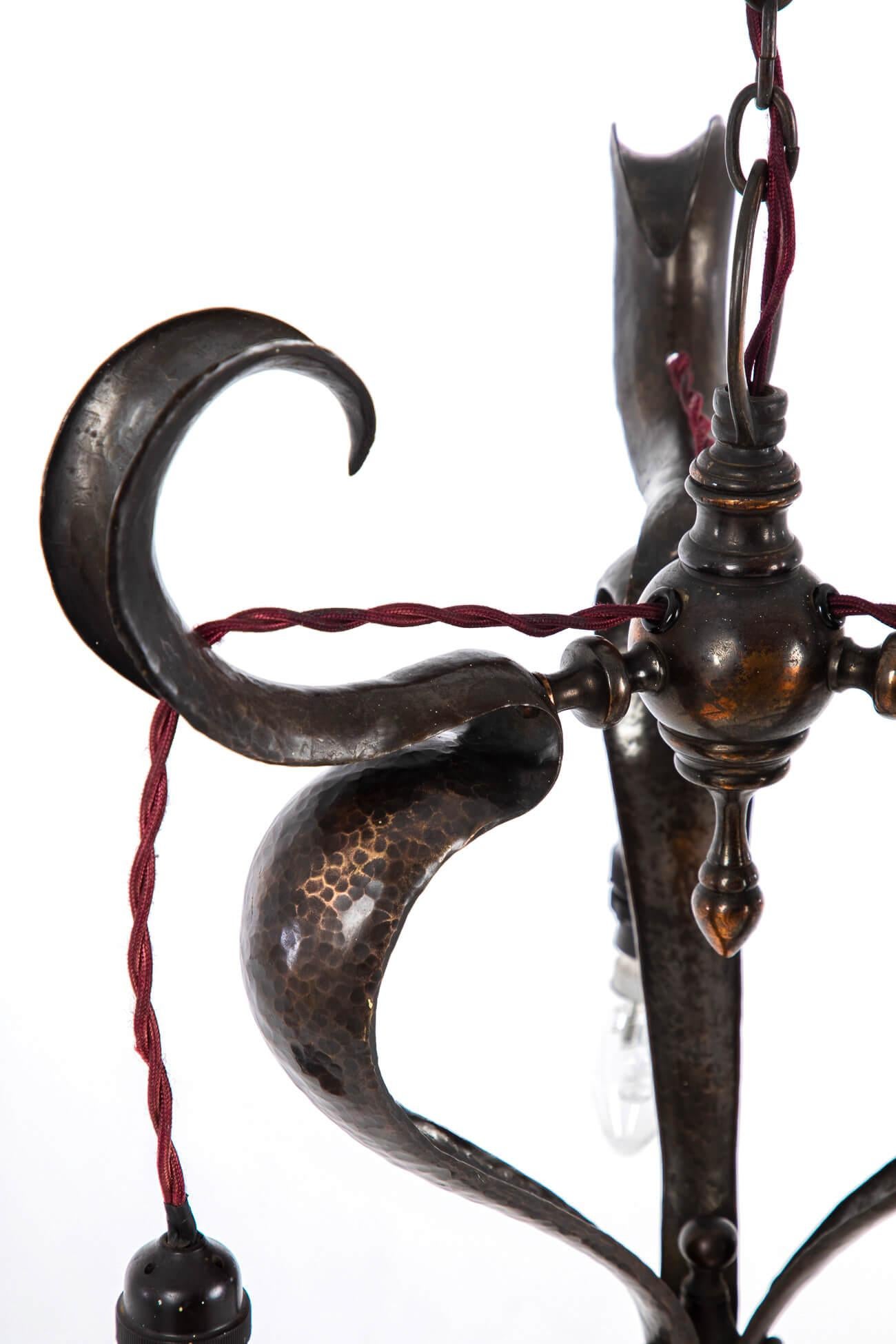 Copper mounted ceiling hook and rose above three bayonet light fittings. With elegant graceful lines highlighted by beautiful curved forms. 
British, circa 1900.

Additional information:
H 80 cm (H 31.4 inches)
W 34 cm (W 13.3 inches).