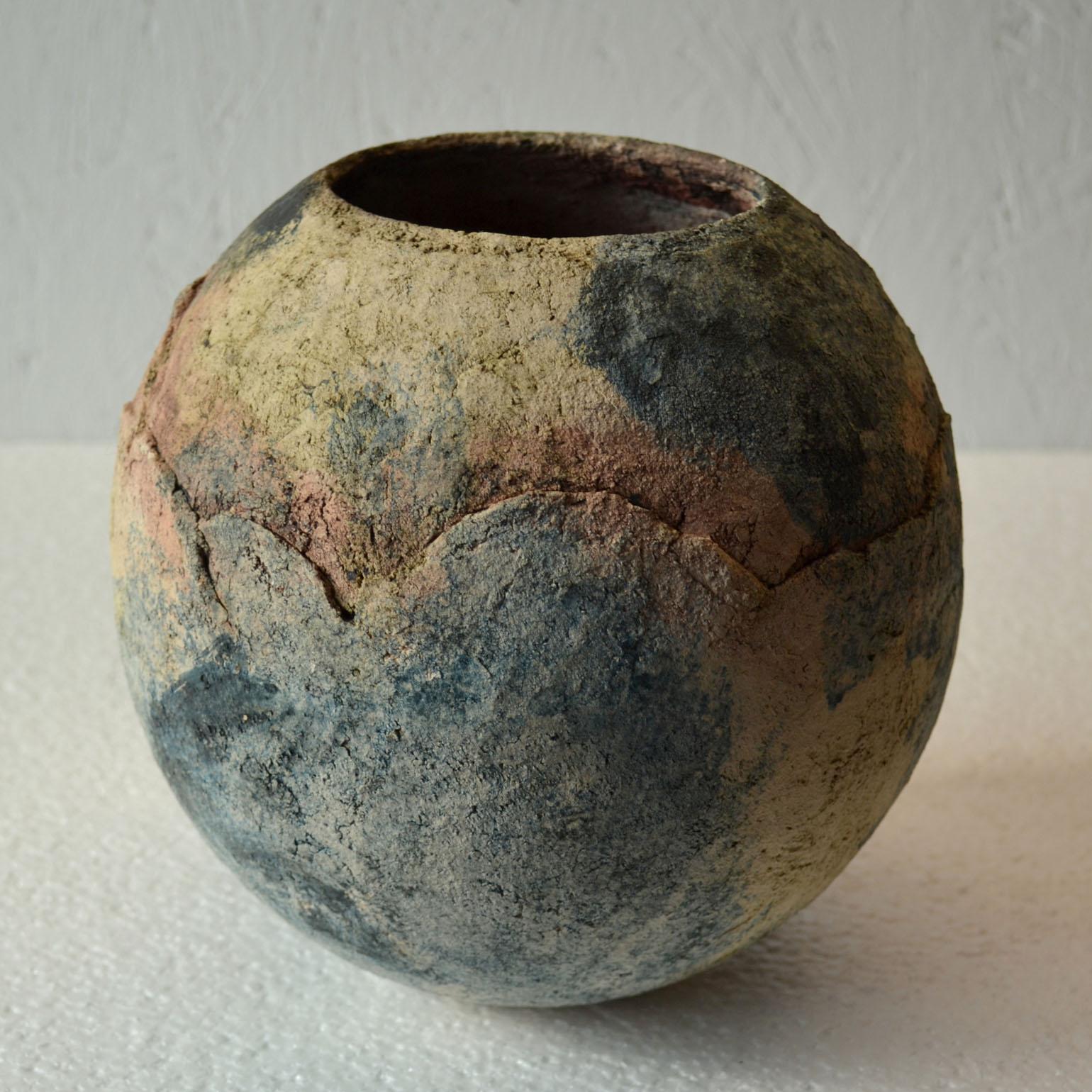 Rough textured ball shape Studio Pottery vase looks lithe the surface of the moon in dark pastel tones. The vase is hand formed with pigmented clay, Dutch, 1980s.