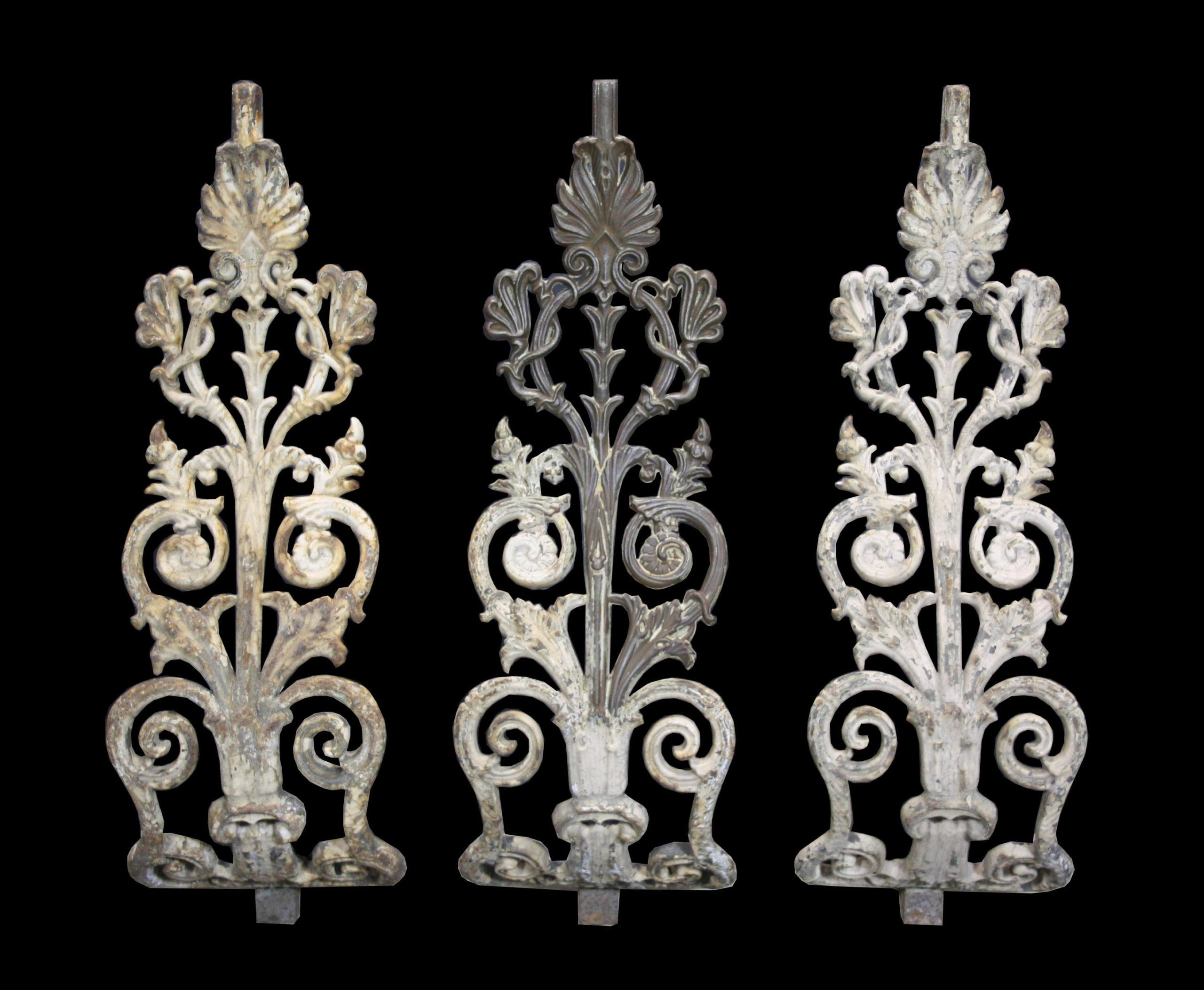 A Set of twenty one shaped cast iron balustrades with scrolling and anthemion decoration.