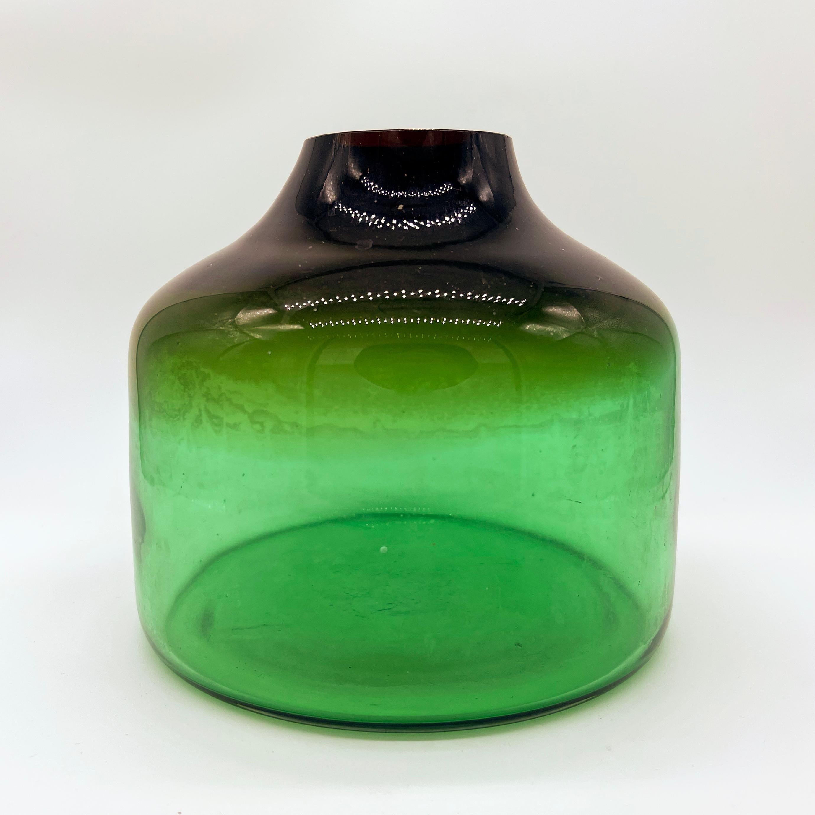 Vintage big and massive vase in thick Murano glass by Italian designer Vinicio Vianello, deep bottle green with a yellowish hue near the top. Dating back to the late Sixties / early Seventies, the vase is a stunning design piece and is still very