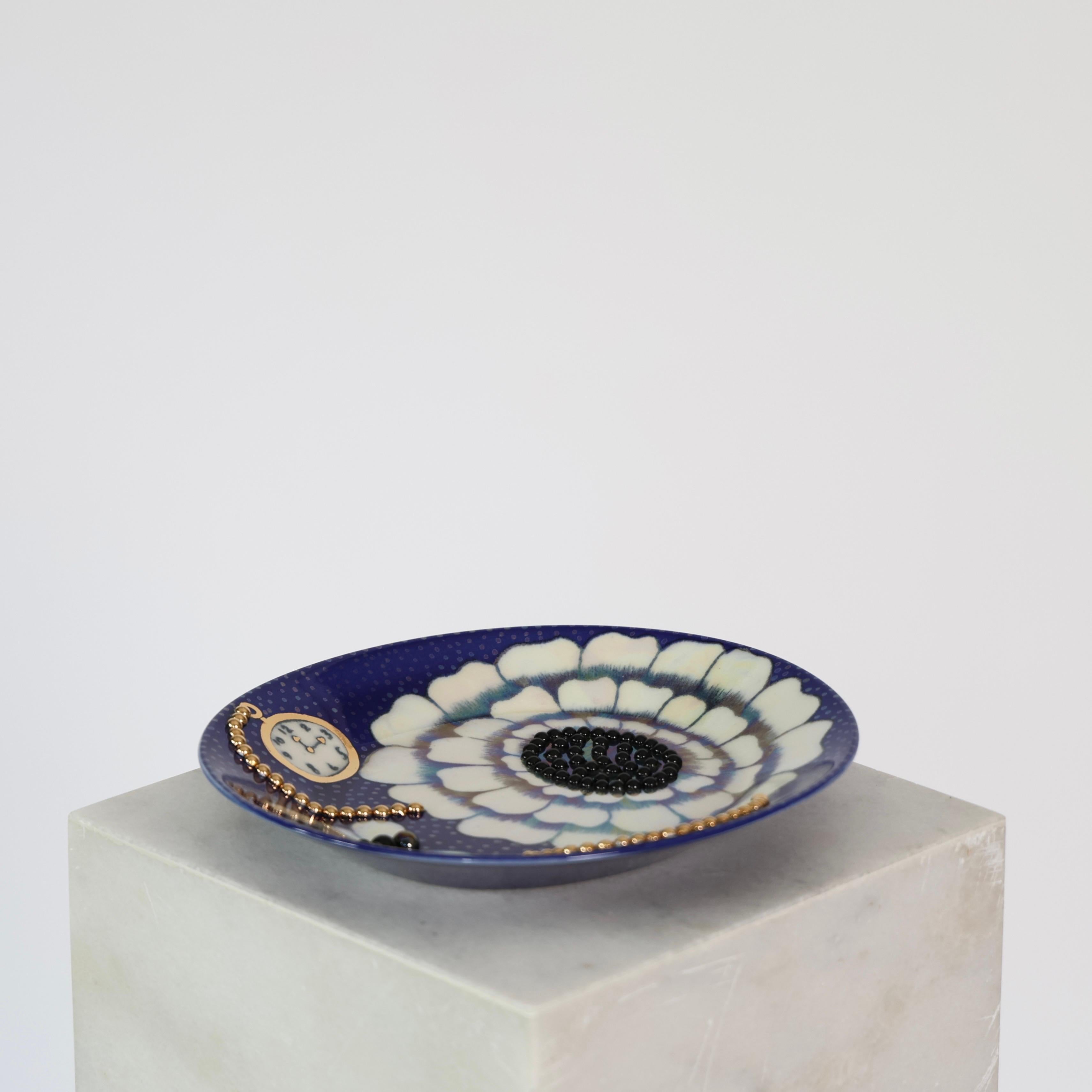 Decorative Blue Dish with gold beads designed by Birger Kaipiainen for Arabia in the 1984. 

* Oval Hand-Painted Blue Dish with pocket watches, flower and butterfly motives and gold beads decorations. 
* Designer: Birger Kaipiainen
* Manufacturer: