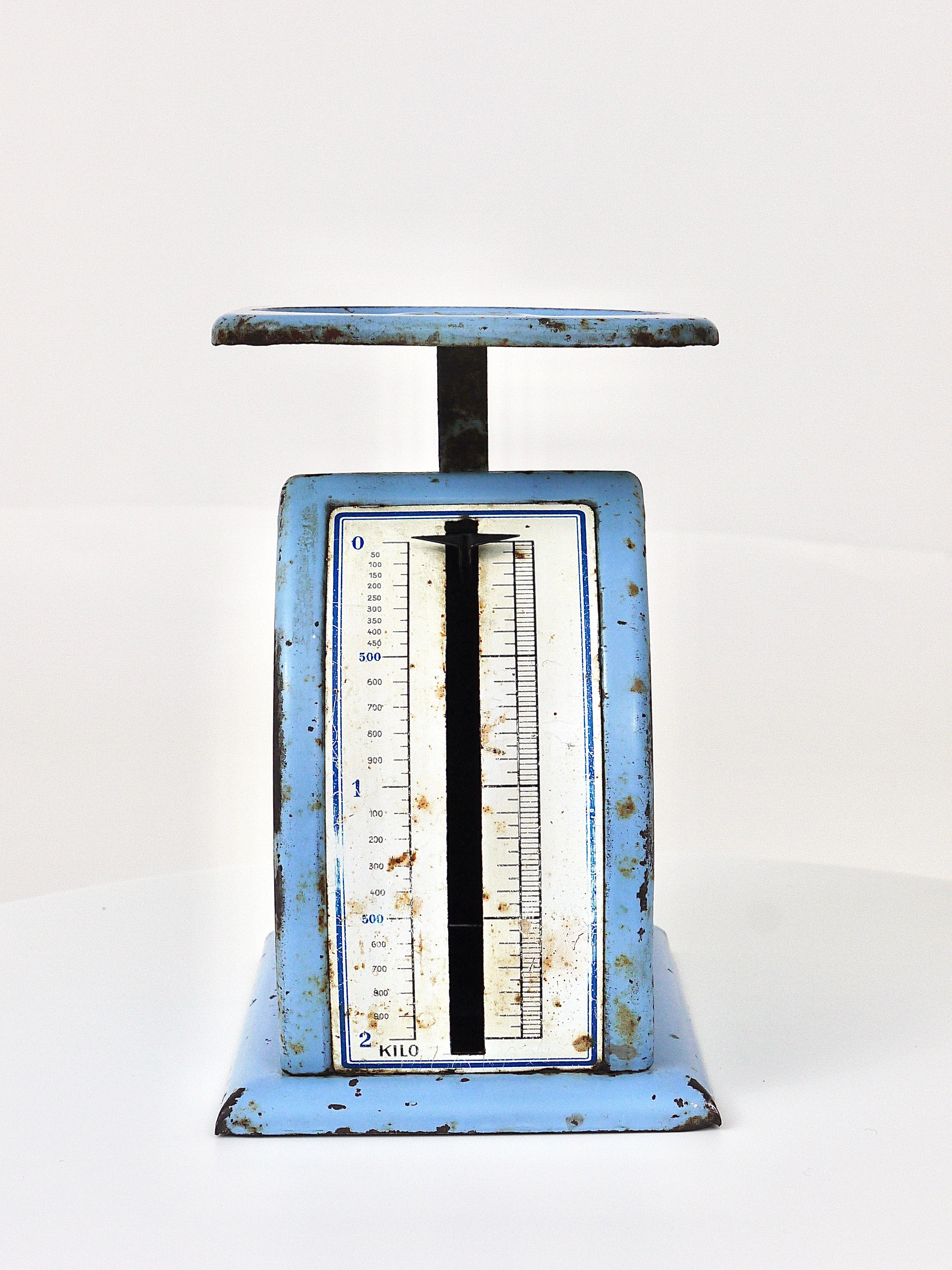 An iconic light-blue sheet metal postal letter scale from the1930s in blue, designed by Marianne Brandt, executed by Ruppel Werke, Ruppelwerk in Gotha, Germany. In original and working condition with charming signs of age.