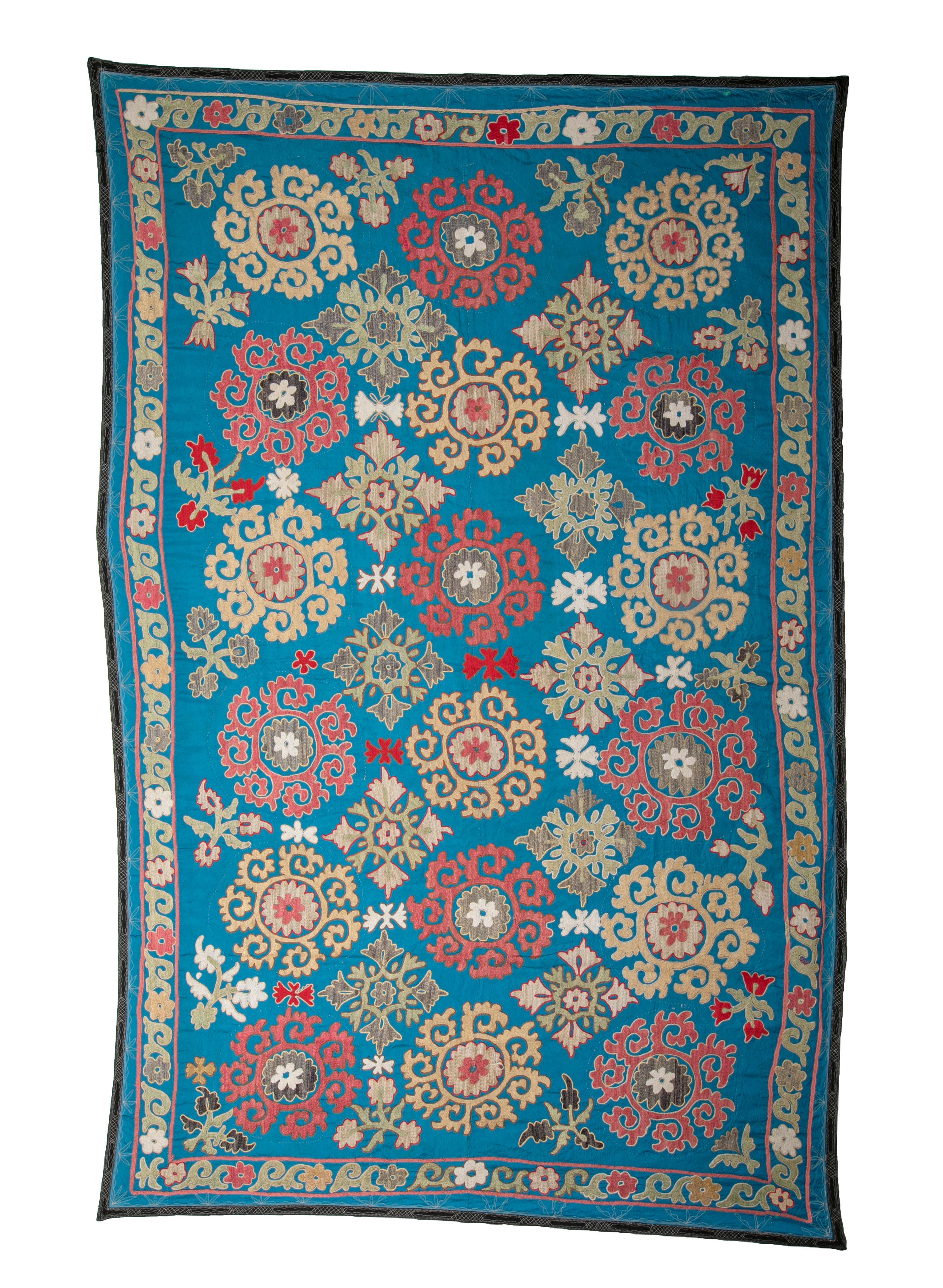 This is a highly decorative suzani from 1970s , with cotton embroidery on a rayon background and lined with light cotton.
