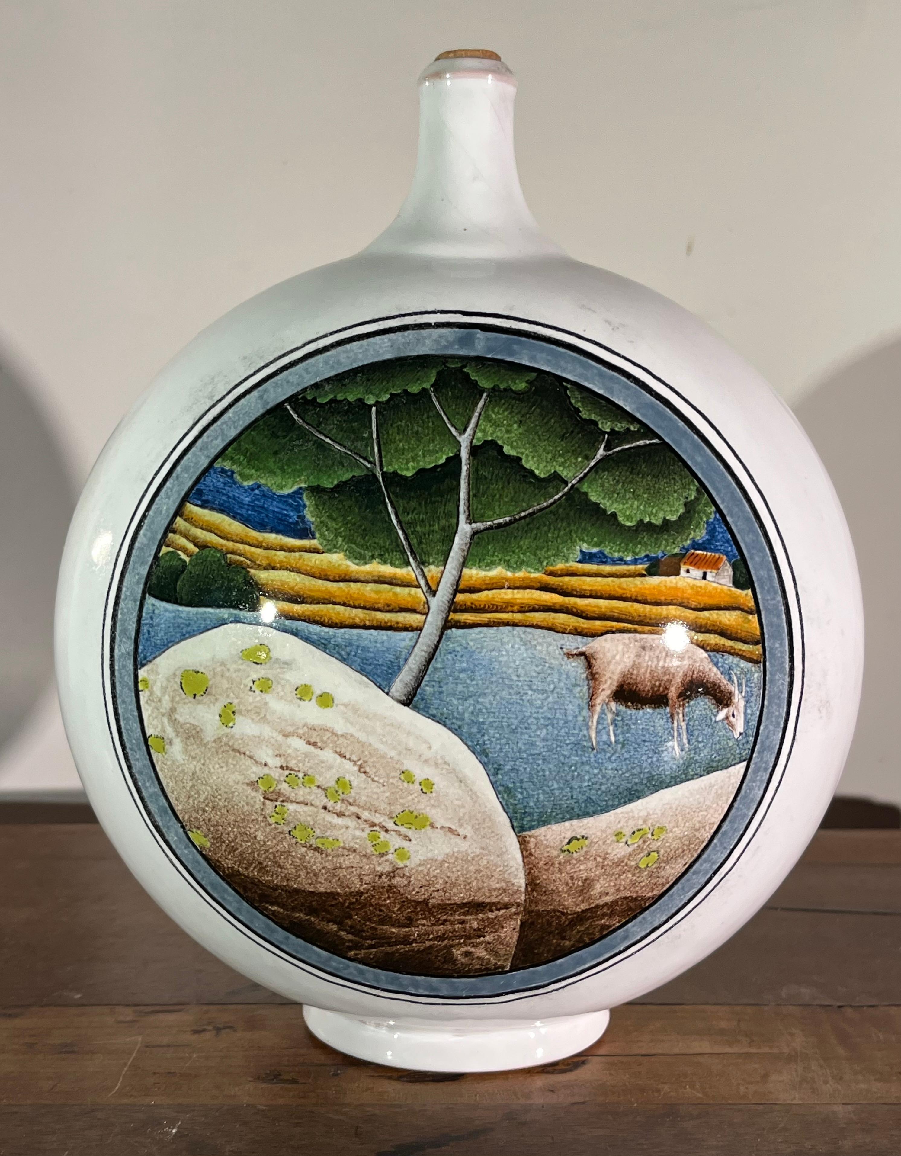 A charming decorated bottle in hand-painted faience, by Claude (1927-2008) and Slavik (1920-2005) Palley. The Palleys created their pieces in Ivy-Sur-Seine France and were exclusively represented by Pierre Deux through the 70’s and 80’s. This