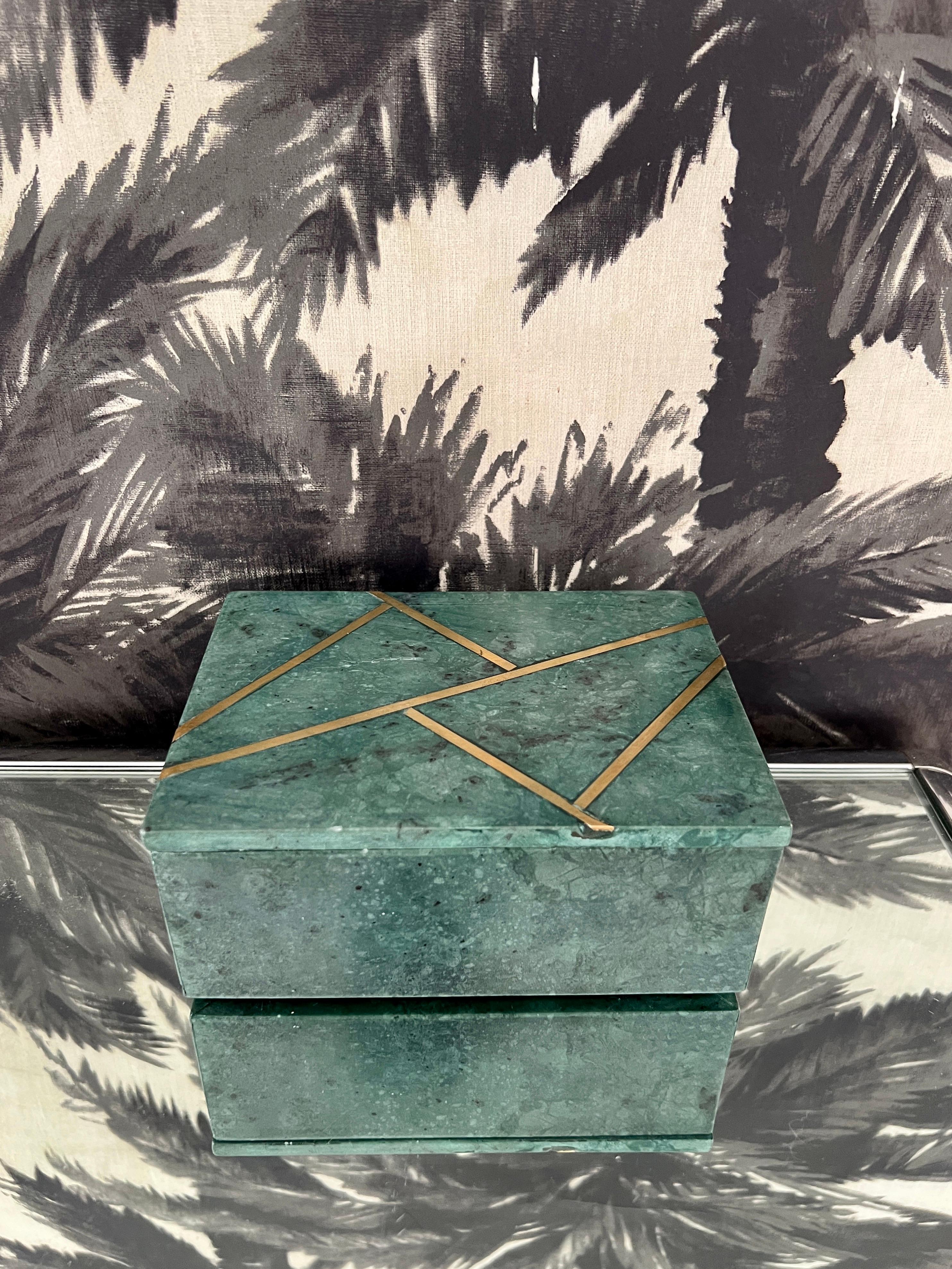 Decorative box in green marble featuring geometric brass inlays. Verde Guatemala marble is an opulent stone in hues of deep green with black spotting or veining. Quarried in India and has been handcrafted by local artisans. Removable lid makes for