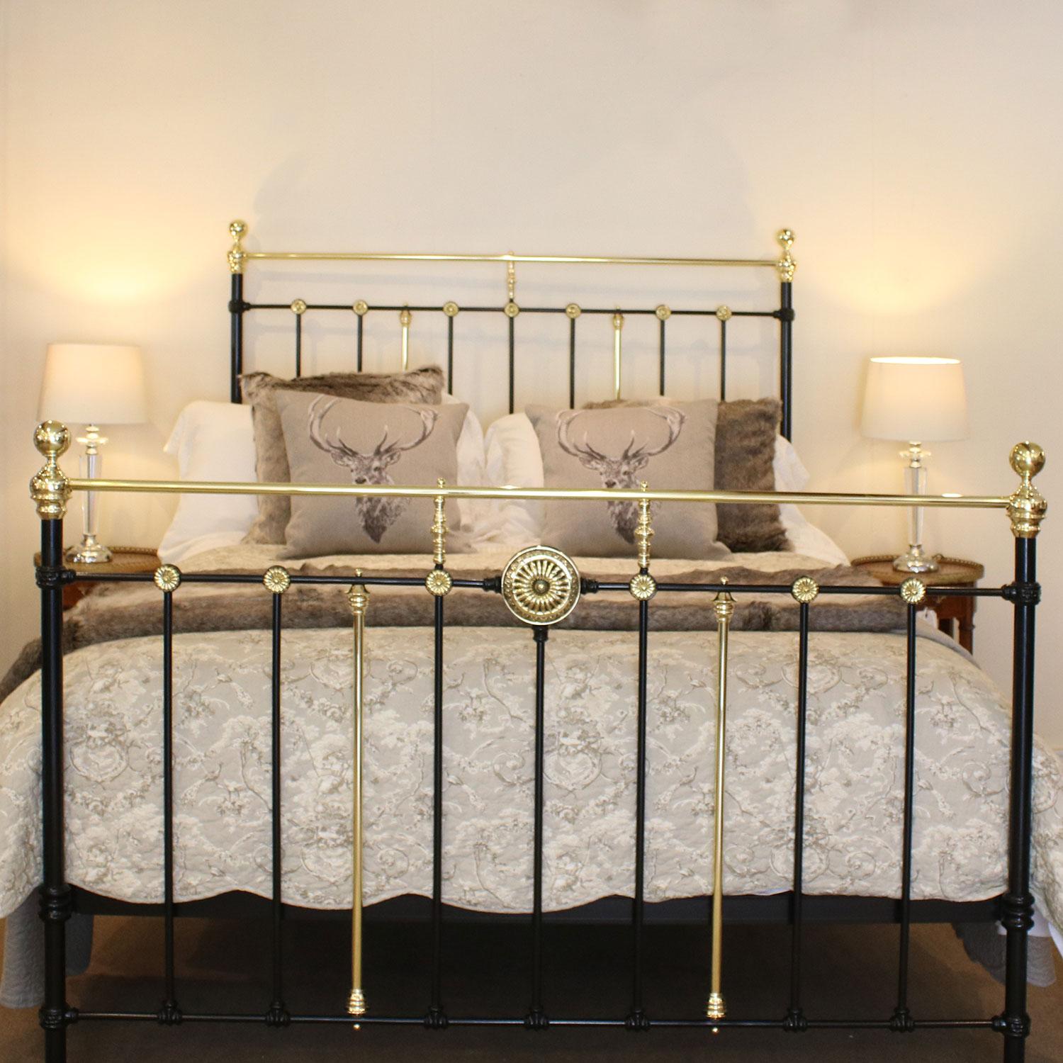 A brass and iron bedstead adapted from an original Victorian frame, finished in black with decorative brass rosettes.

This bed accepts a British king-size or US queen-size (measure: 5ft, 60 in or 150cm wide) base and mattress set.

The price is